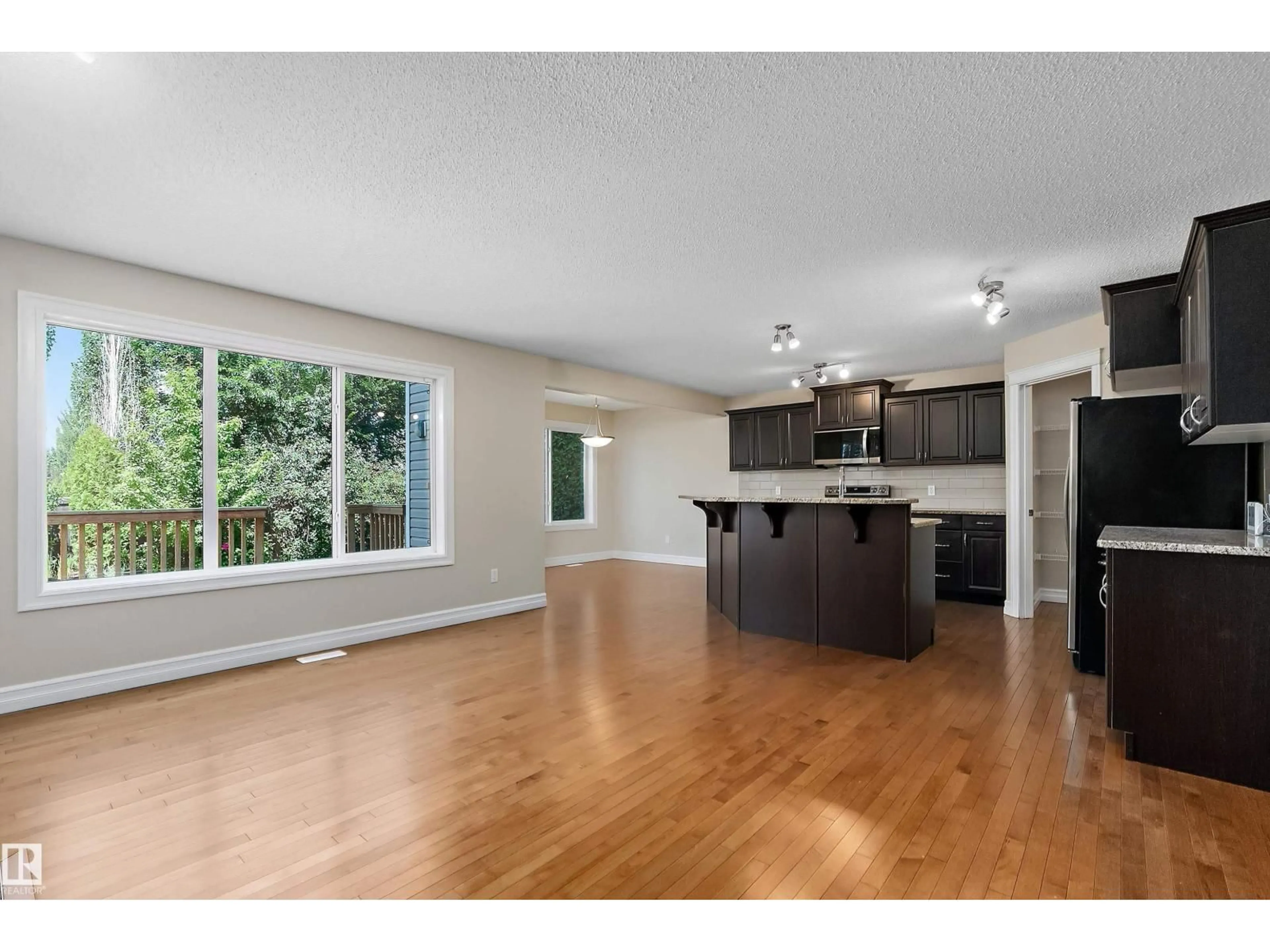 Open concept kitchen, wood/laminate floor for 17330 8A AV SW, Edmonton Alberta T6W0M8