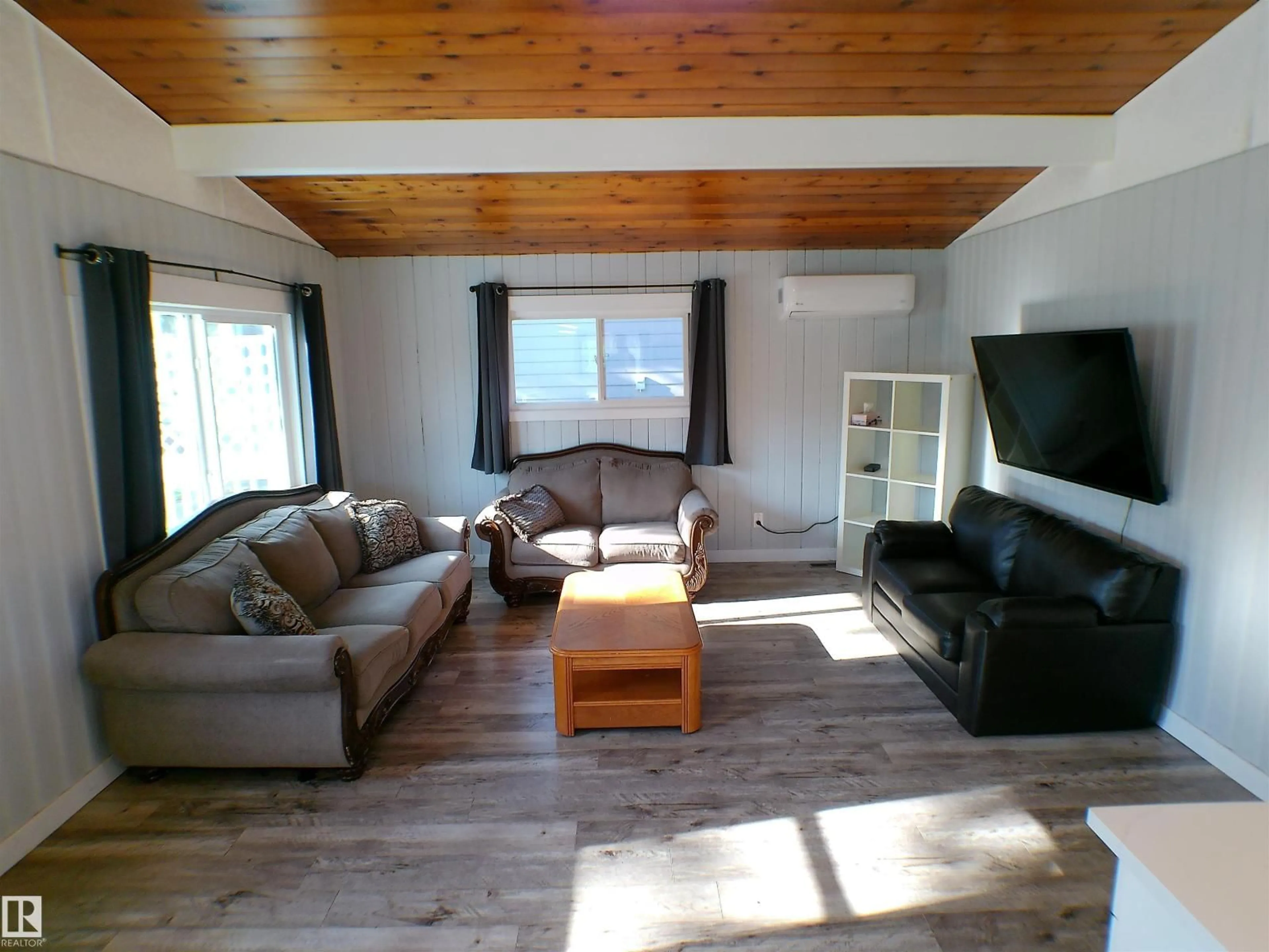 Living room with furniture, wood/laminate floor for 708 7 ST, Rural Lac Ste. Anne County Alberta T0E1A0
