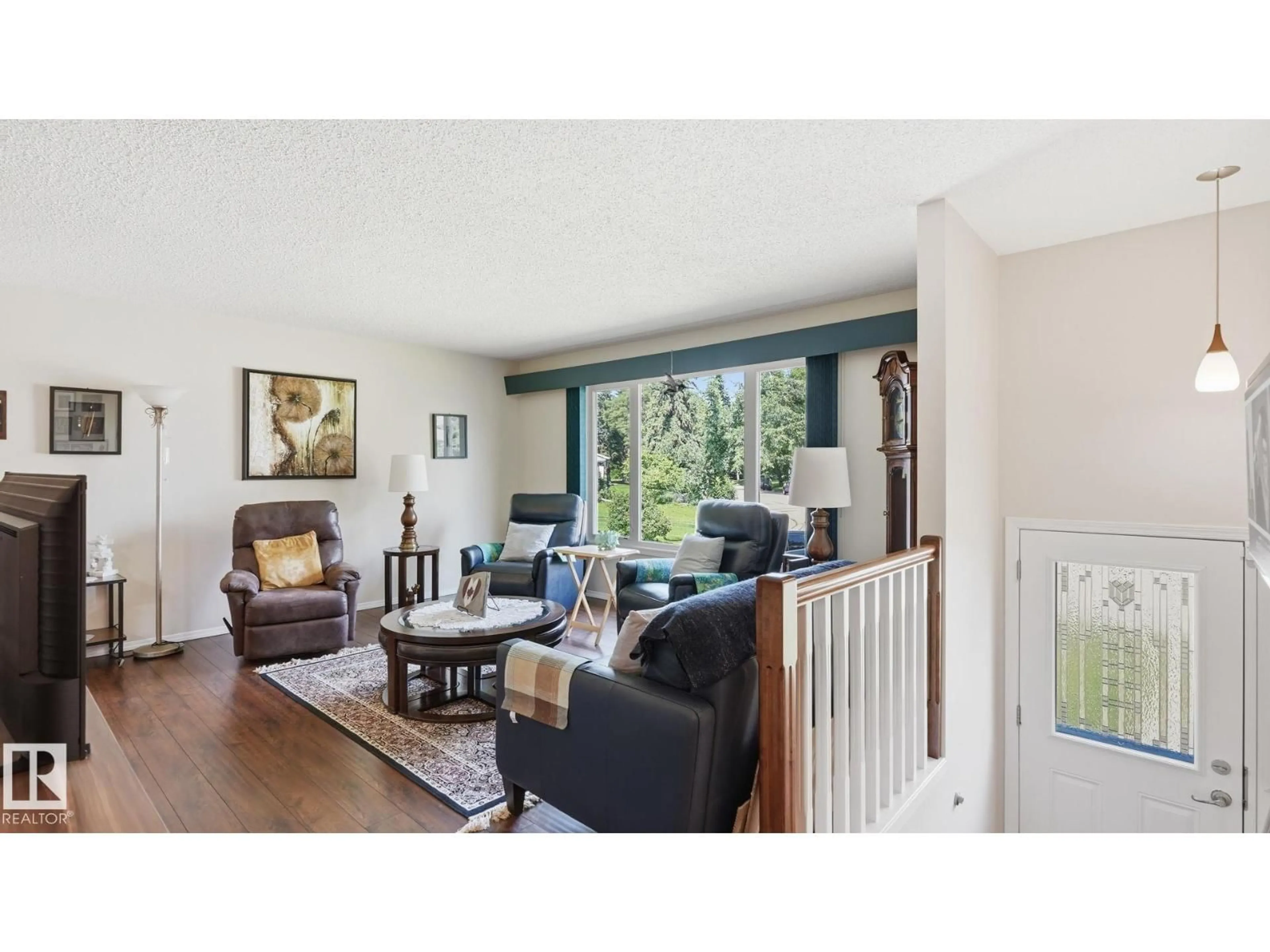 Living room with furniture, wood/laminate floor for 4515 41A AV, Leduc Alberta T9E4Z2