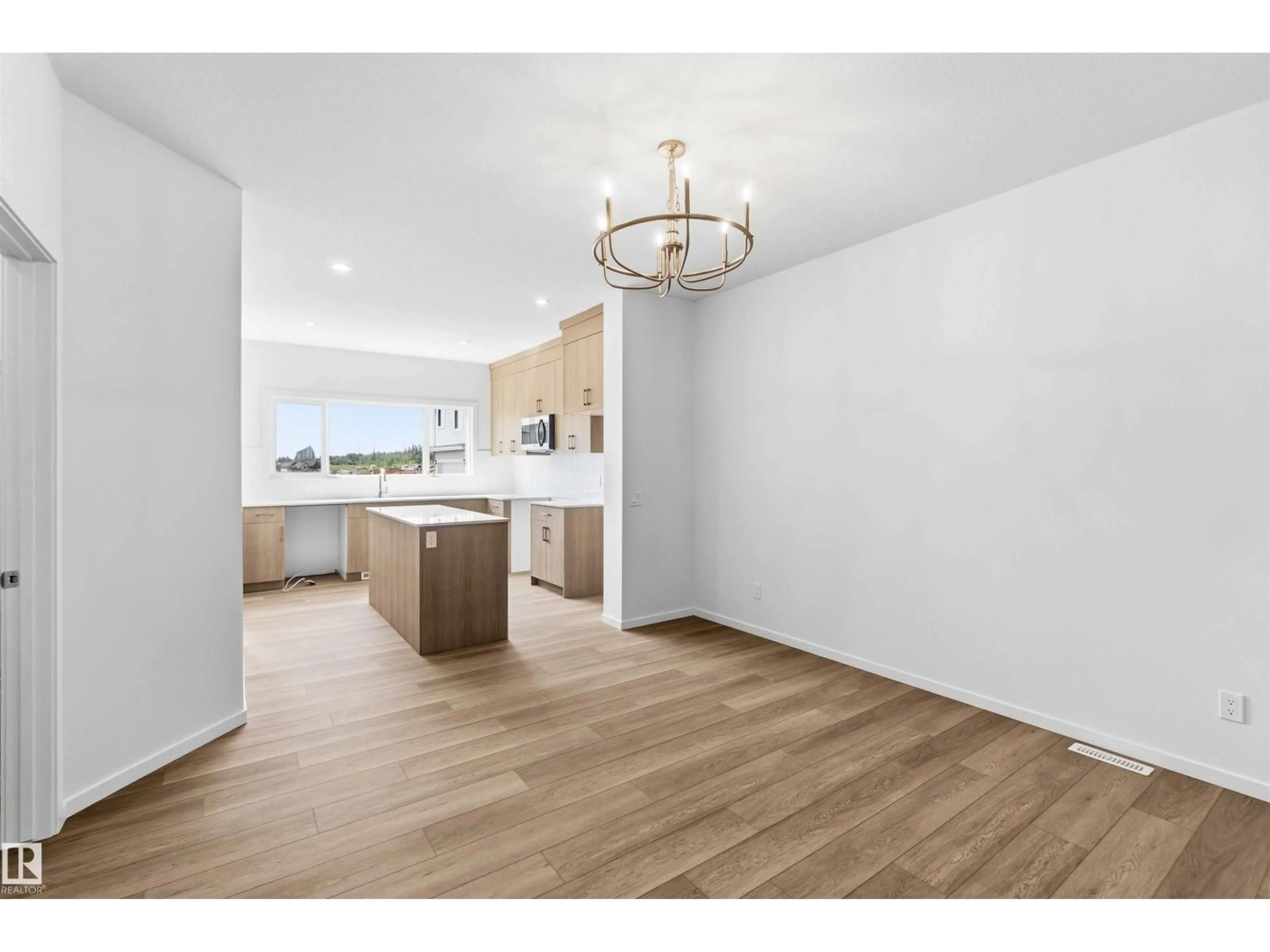 Open concept kitchen, wood/laminate floor for NE NE - 223 157 AV, Edmonton Alberta T5Y4M3