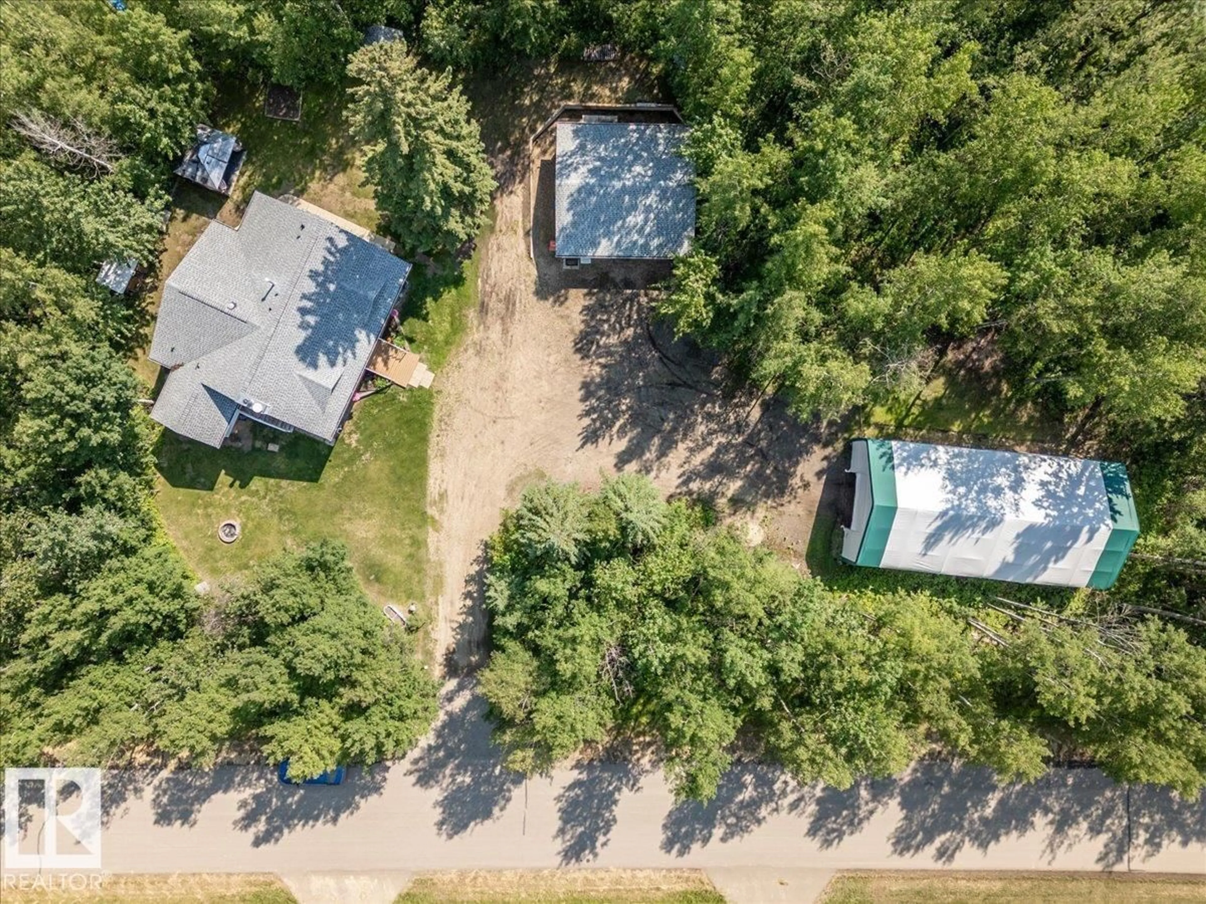 A pic from outside/outdoor area/front of a property/back of a property/a pic from drone, forest/trees view for 5502 39 ST, Rural Wetaskiwin County Alberta T0C2C0
