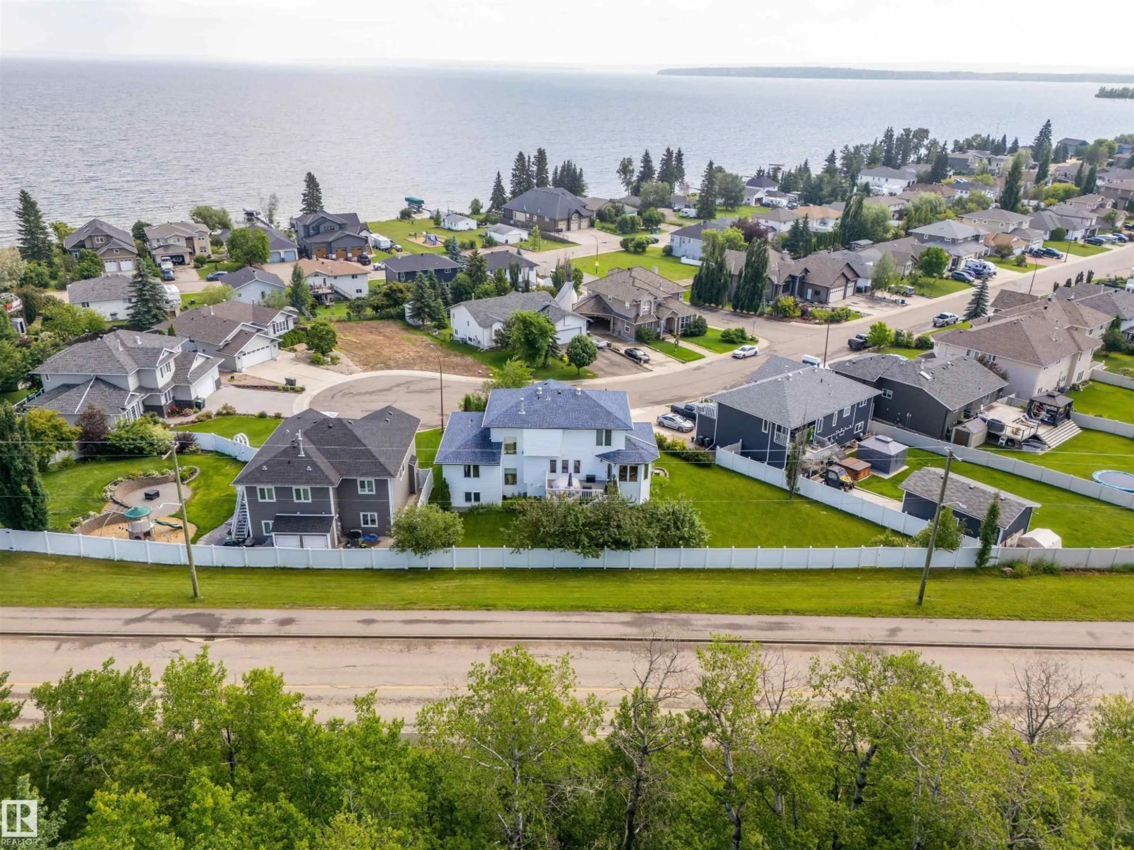 A pic from outside/outdoor area/front of a property/back of a property/a pic from drone, water/lake/river/ocean view for 905 26 ST, Cold Lake Alberta T9M1X8