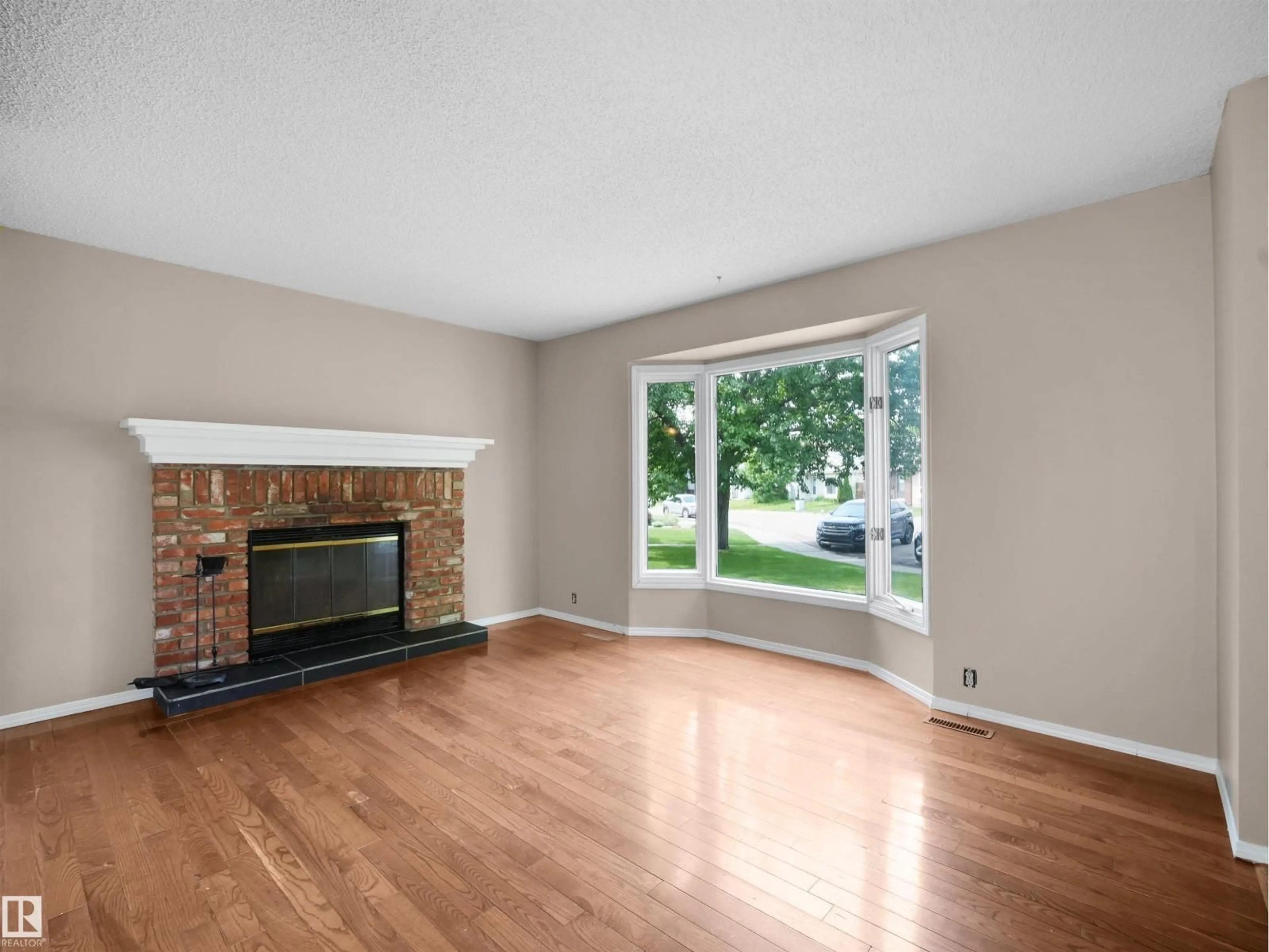 Living room with furniture, wood/laminate floor for 3509 43A AV AV, Edmonton Alberta T7A1G4