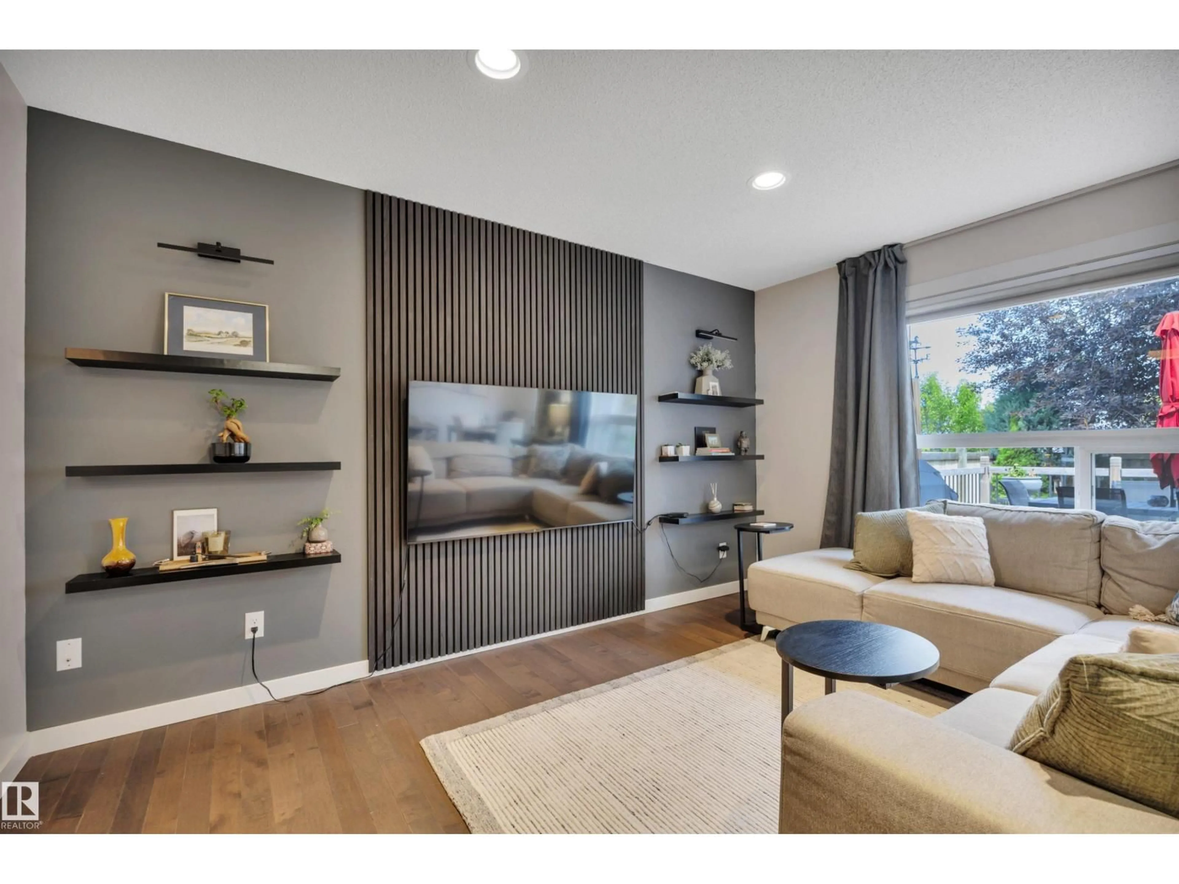 Living room with furniture, wood/laminate floor for 4029 ALEXANDER WY, Edmonton Alberta T6W2C5