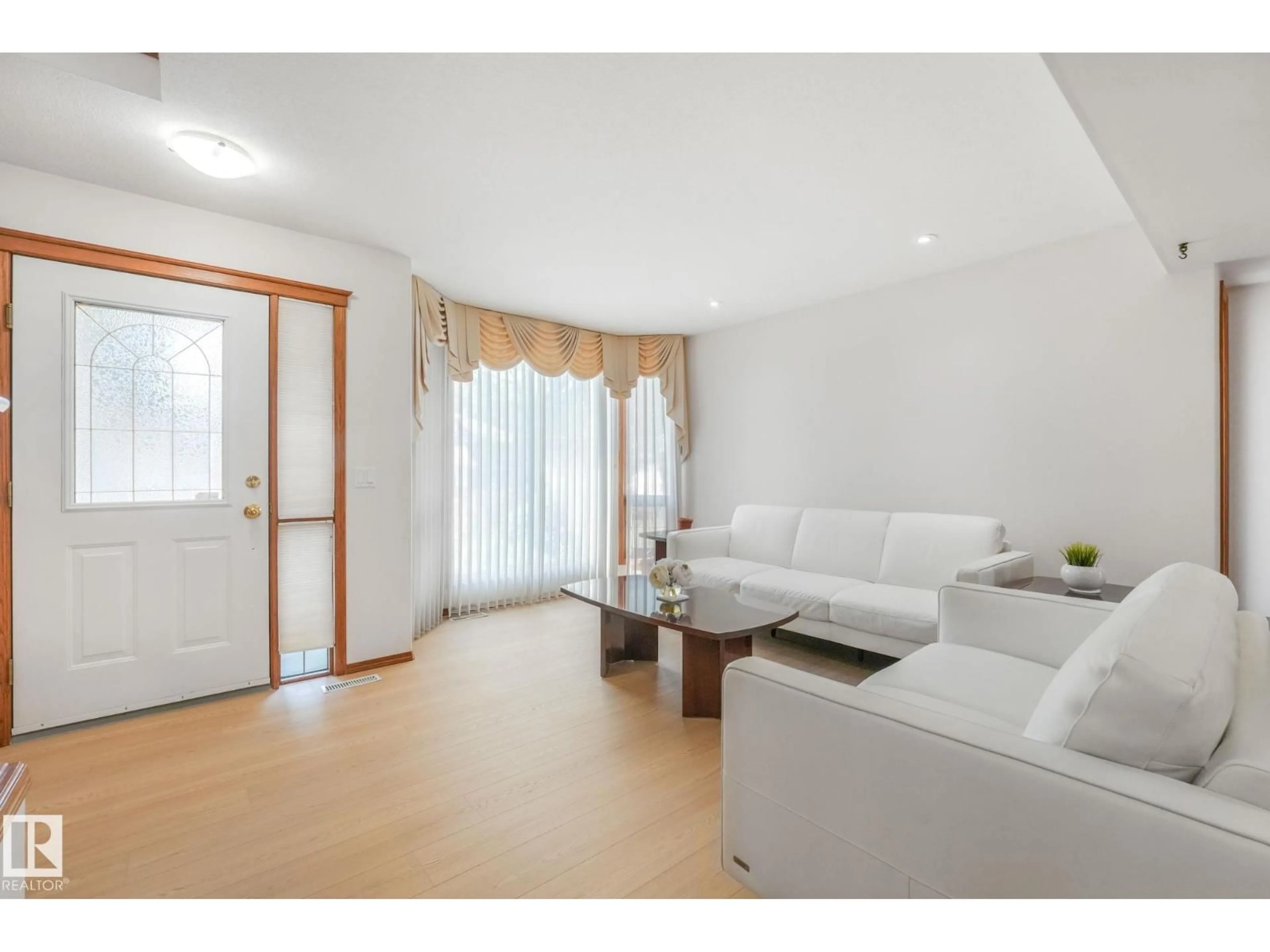Living room with furniture, wood/laminate floor for 177 KULAWY DR, Edmonton Alberta T6L6Z1