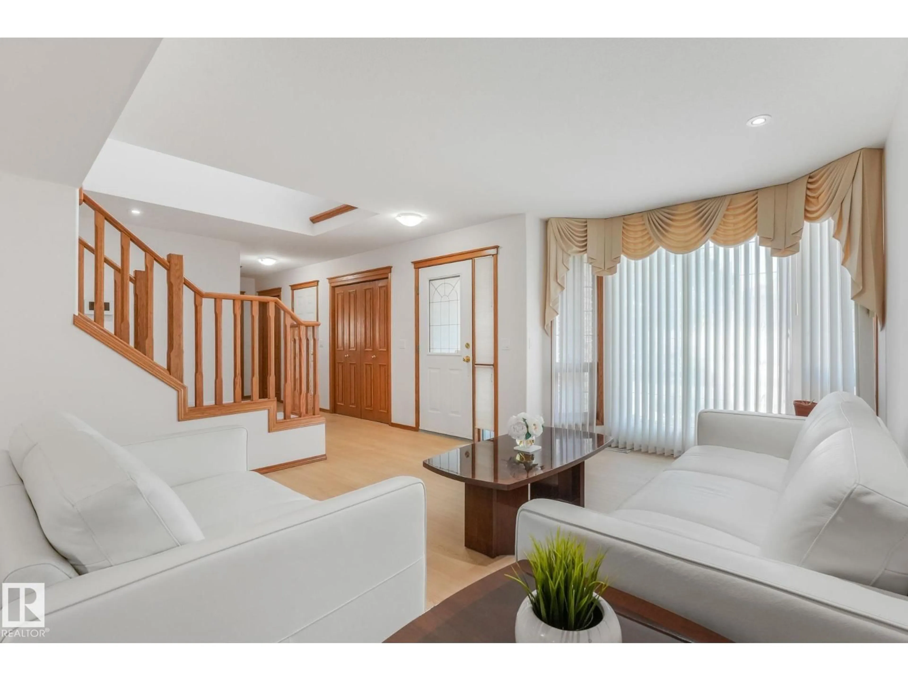Living room with furniture, wood/laminate floor for 177 KULAWY DR, Edmonton Alberta T6L6Z1