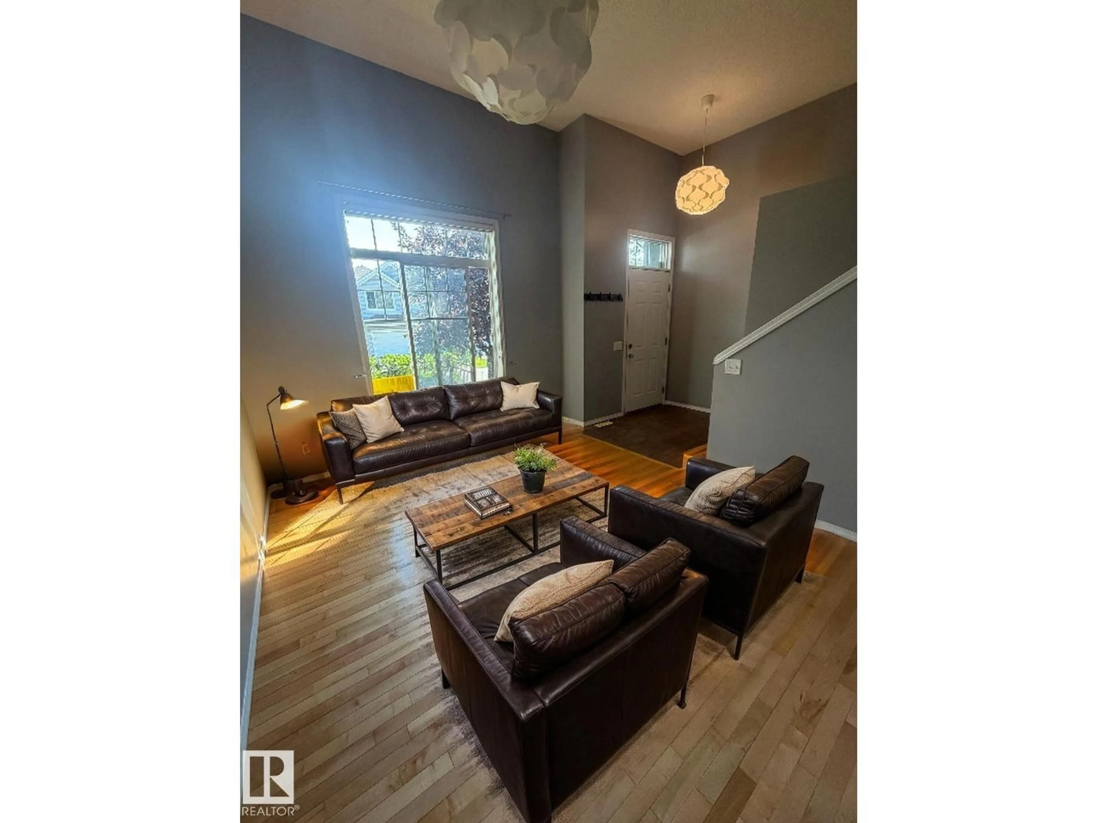 Living room with furniture, wood/laminate floor for #7 - 8304 11 AV, Edmonton Alberta T6X1J8