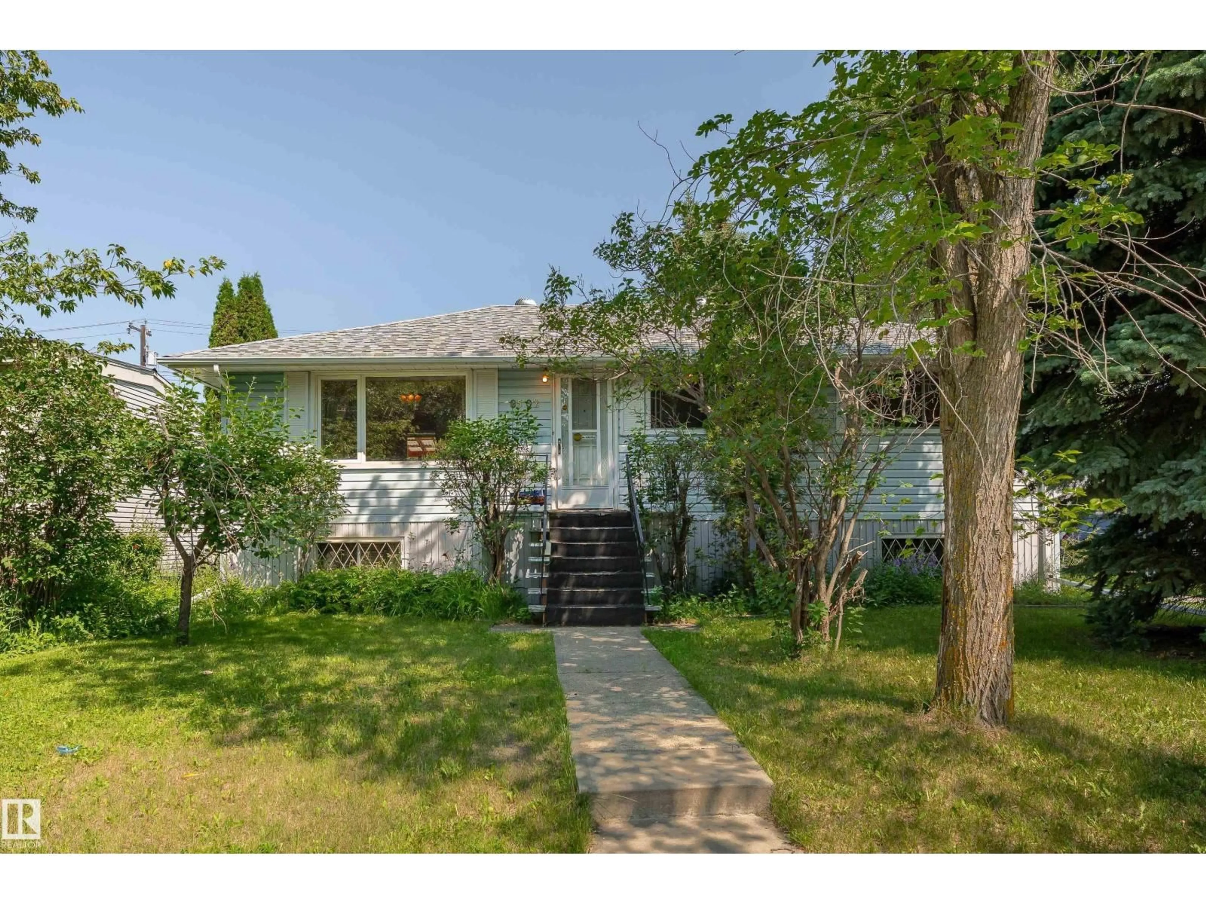 Home with vinyl exterior material, street for 8502 76 AV, Edmonton Alberta T6C0J3