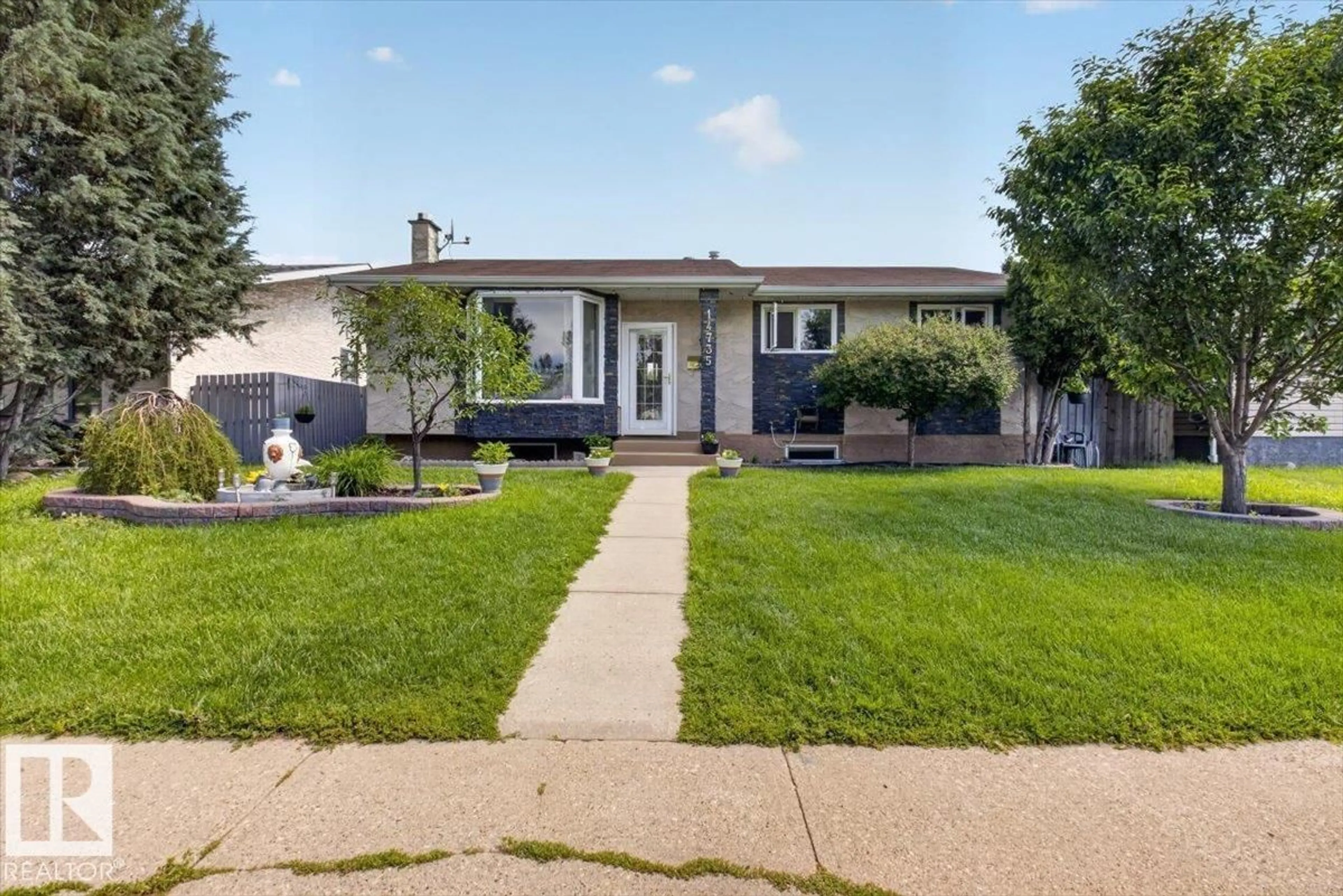 Home with vinyl exterior material, street for 14735 123 ST, Edmonton Alberta T5X1W1