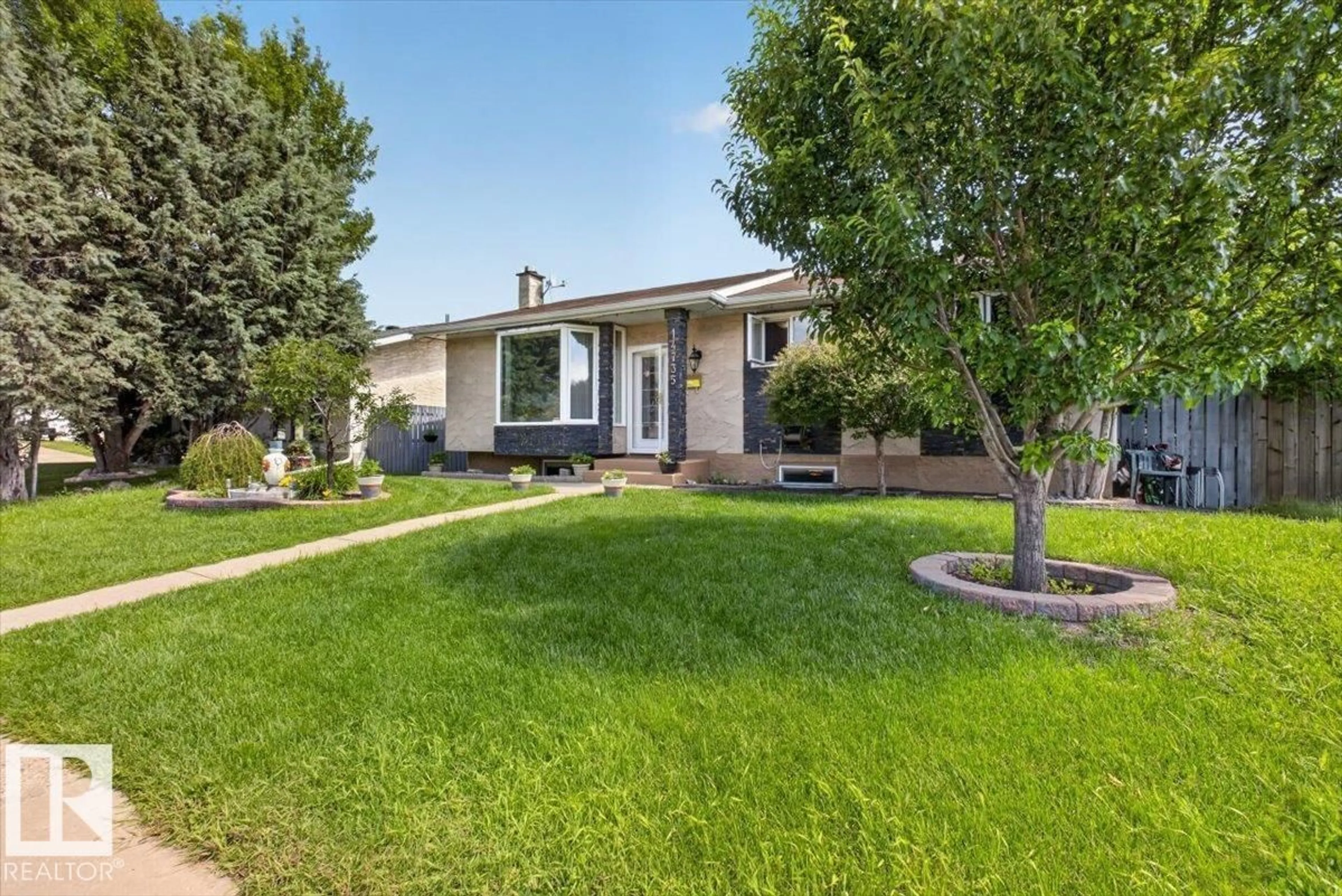 Home with vinyl exterior material, street for 14735 123 ST, Edmonton Alberta T5X1W1