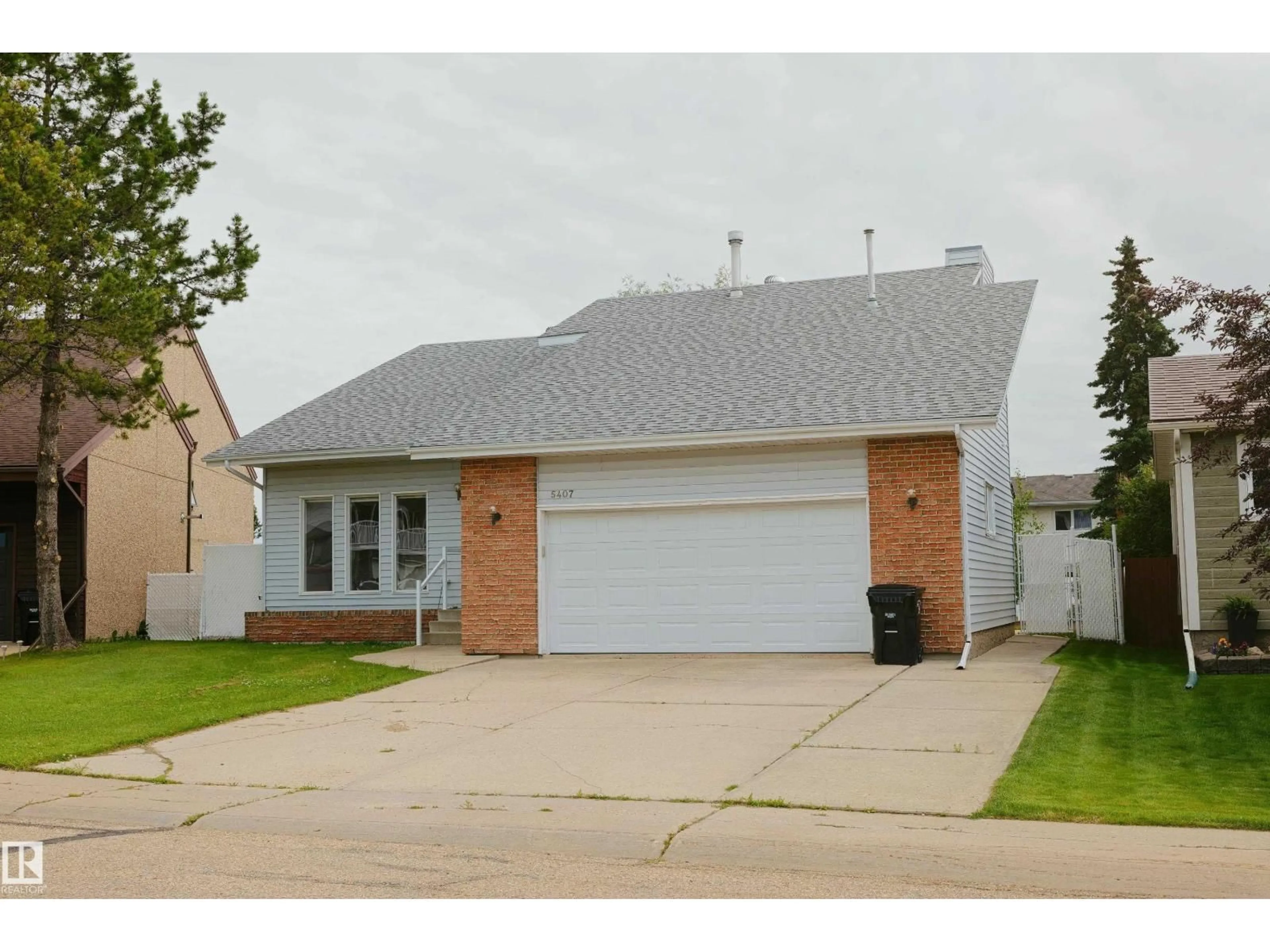 Home with vinyl exterior material, street for 5407 60 AVE, Barrhead Alberta T7N1E1