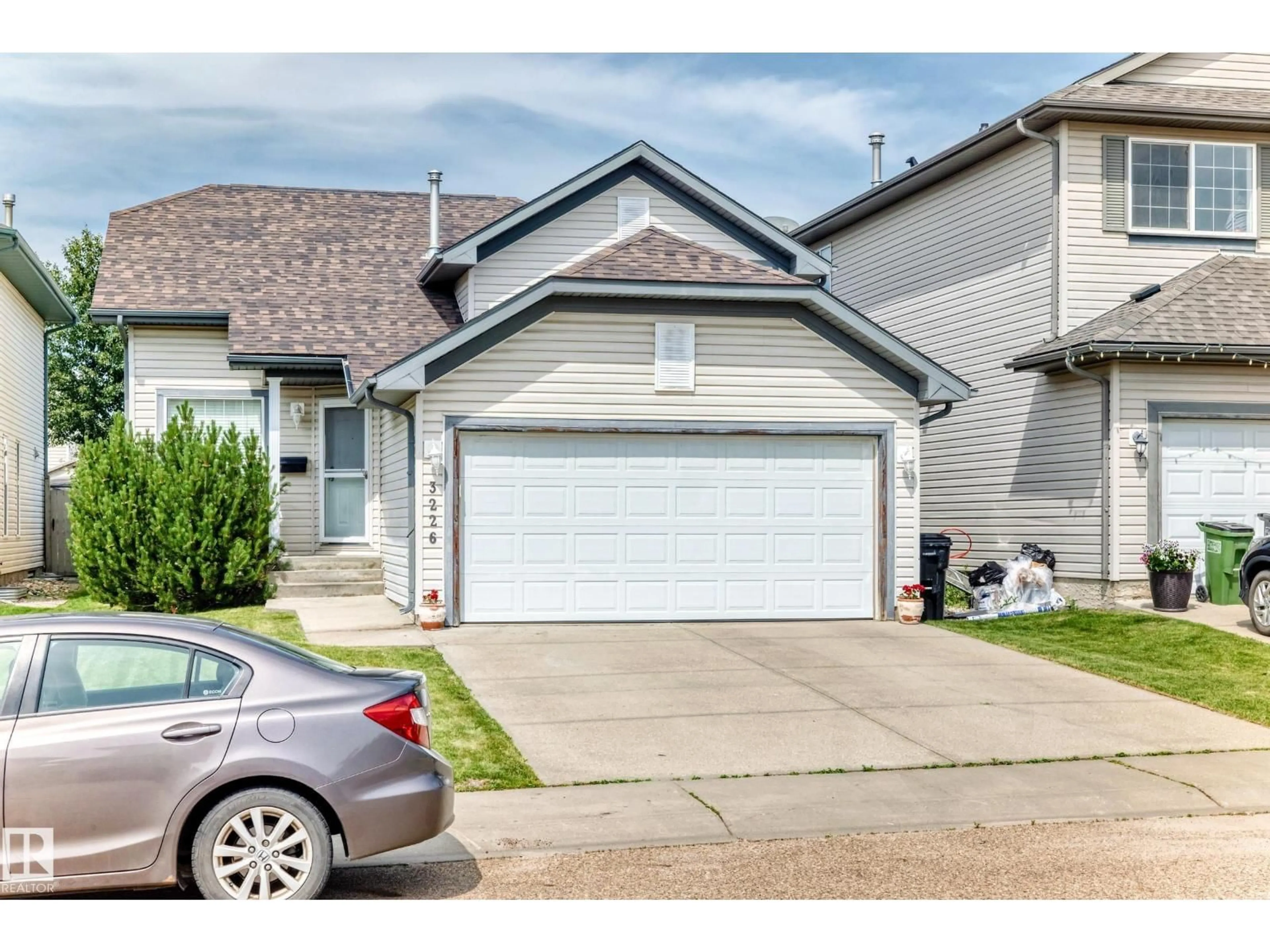 Home with vinyl exterior material, street for 3226 30 AV, Edmonton Alberta T6T1T4