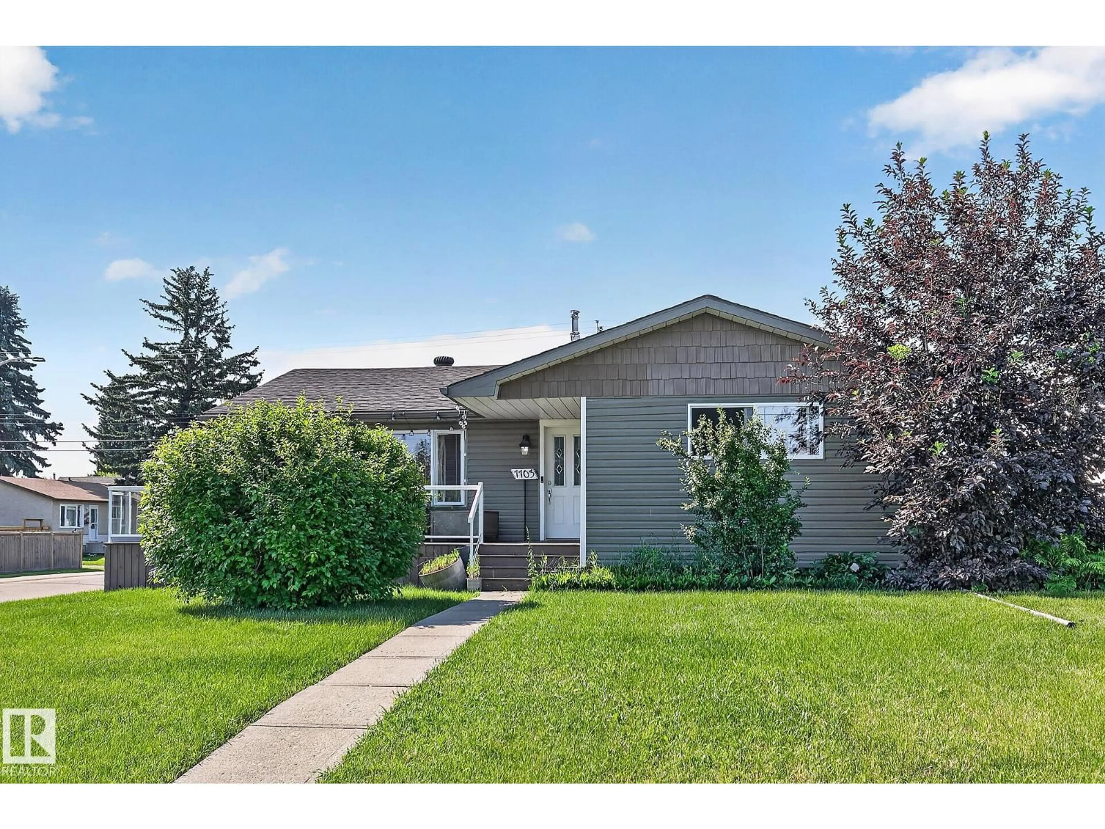 Home with vinyl exterior material, street for 7703 134 AV, Edmonton Alberta T5C2G2