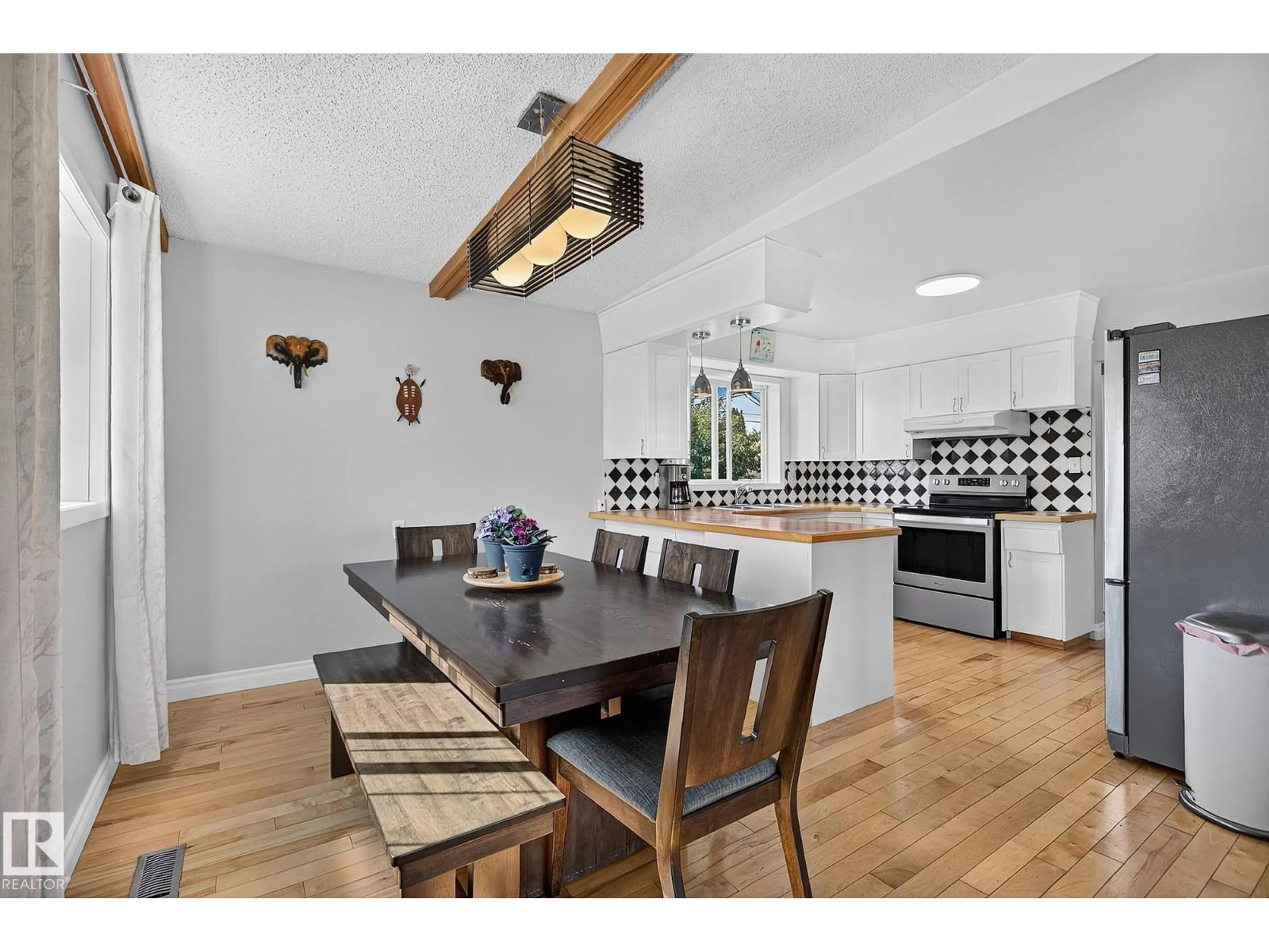 Open concept kitchen, wood/laminate floor for 7703 134 AV, Edmonton Alberta T5C2G2