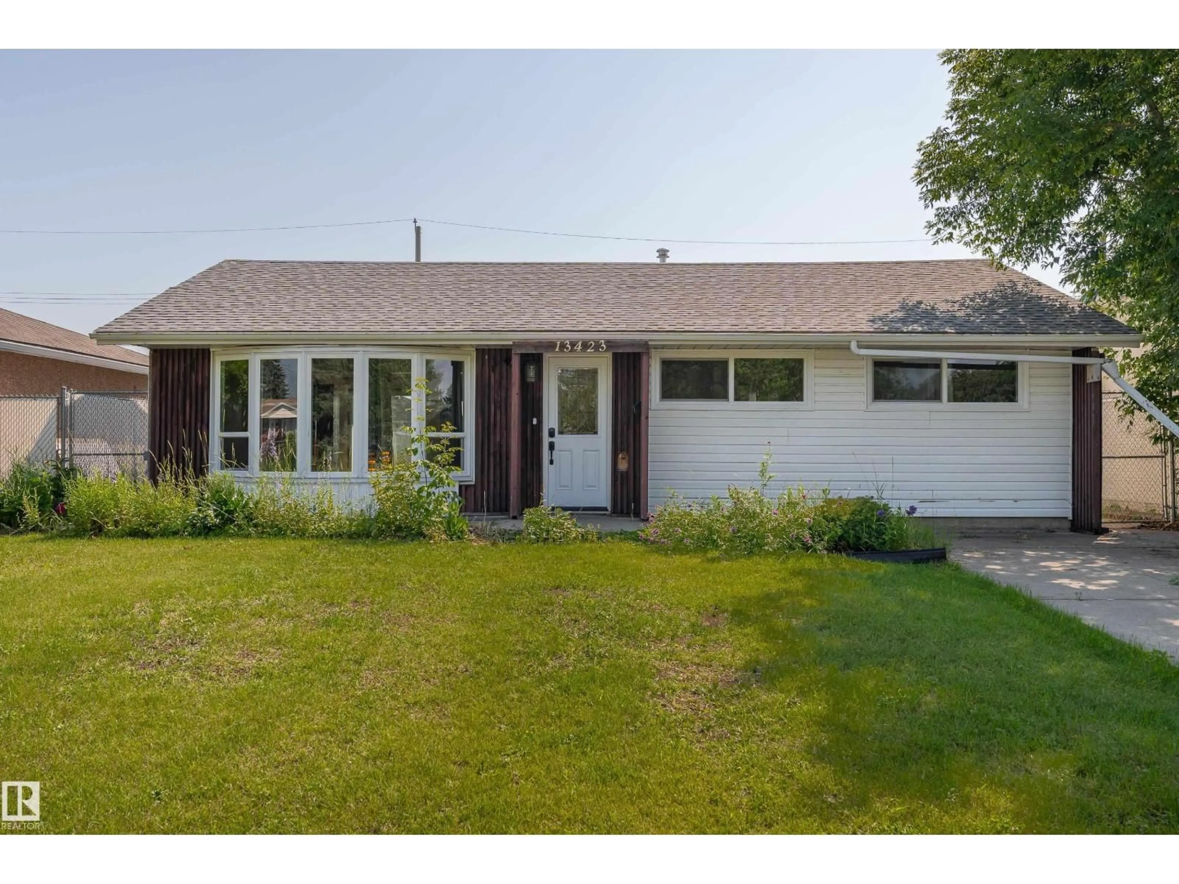 Home with vinyl exterior material, street for NW - 13423 112 ST, Edmonton Alberta T5E5A3
