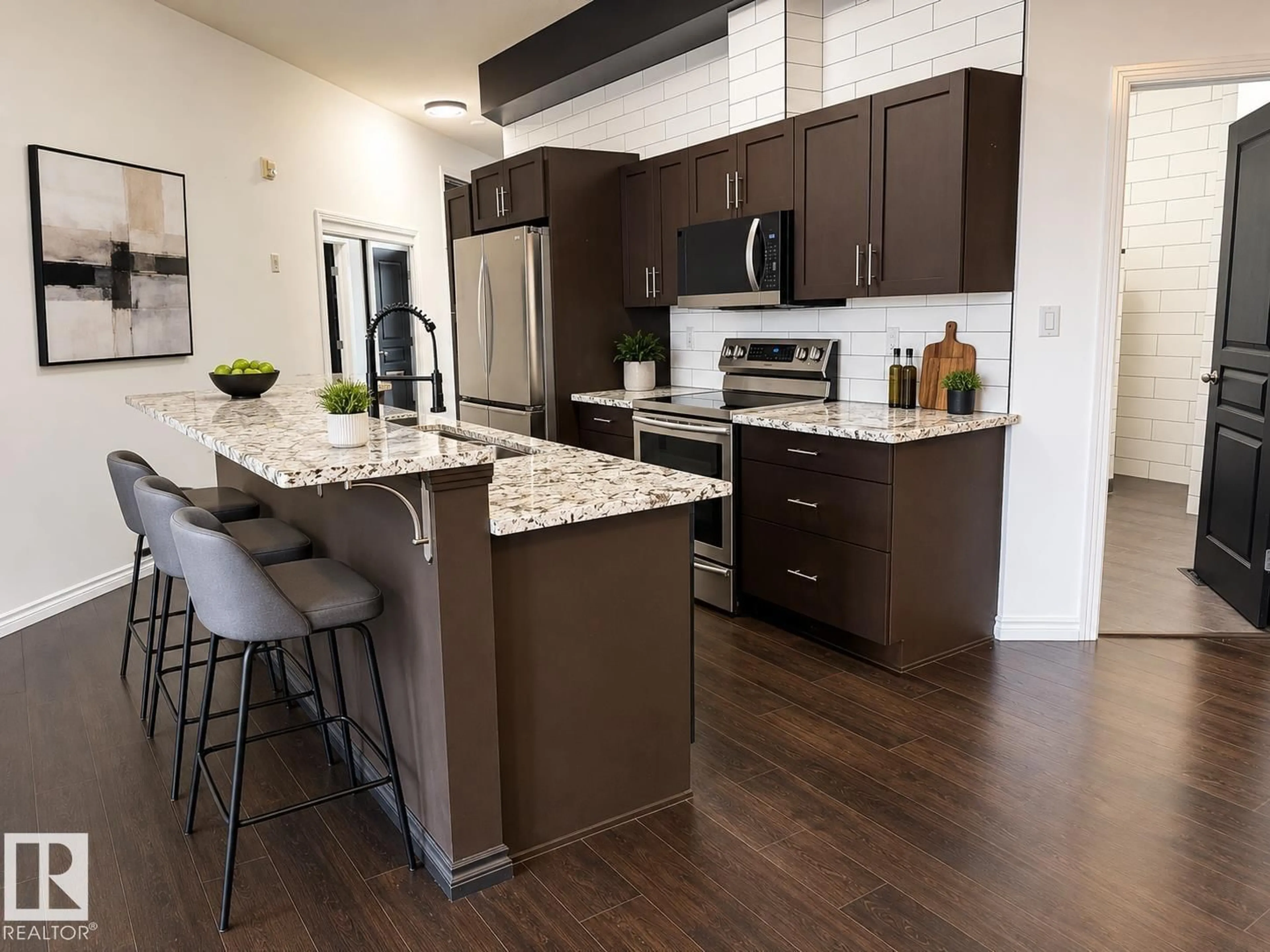 Open concept kitchen, wood/laminate floor for #412 - 9503 101 AV NW, Edmonton Alberta T5H4R1