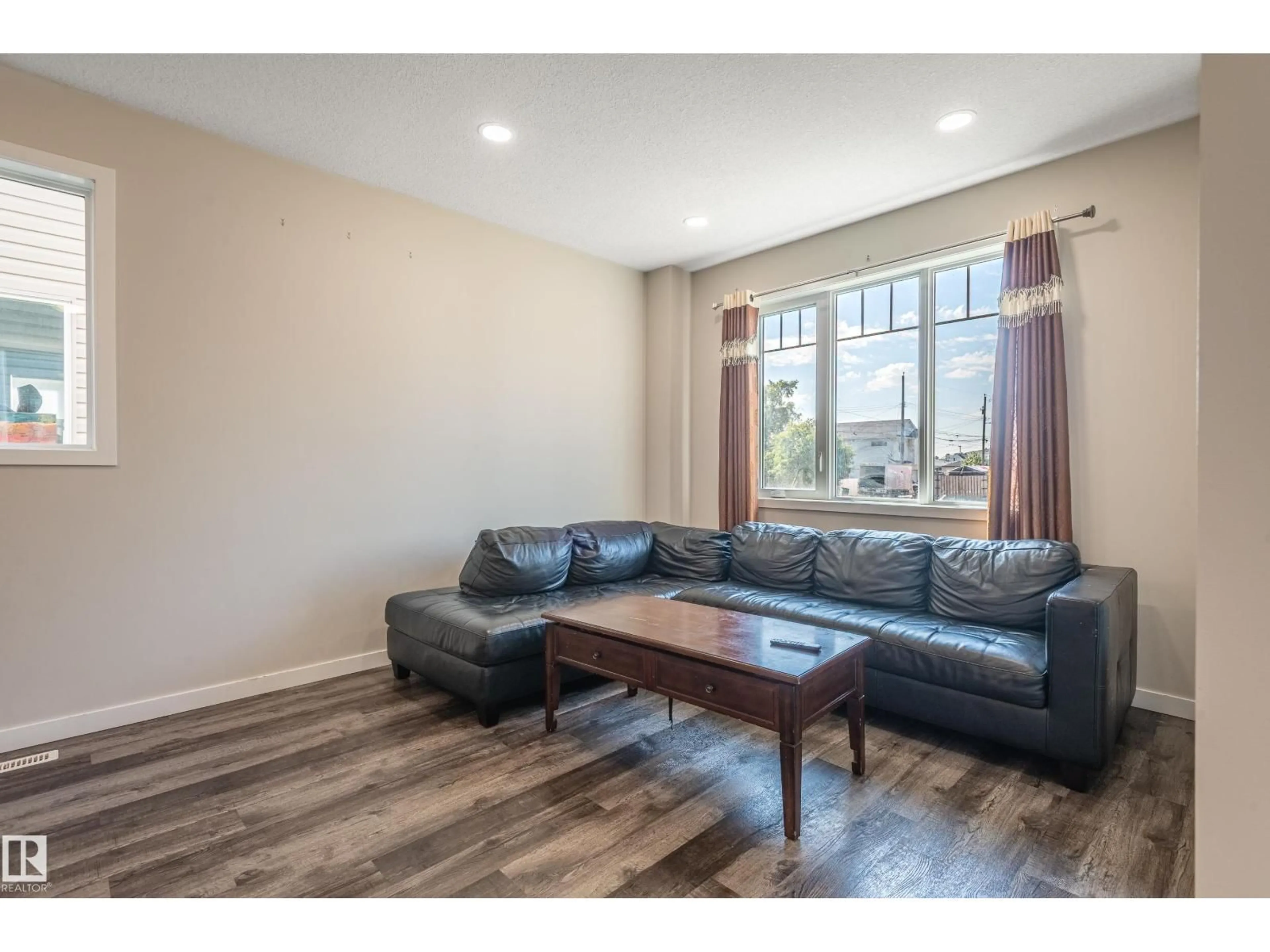 Living room with furniture, wood/laminate floor for 15928 100 AV, Edmonton Alberta T5P0L2