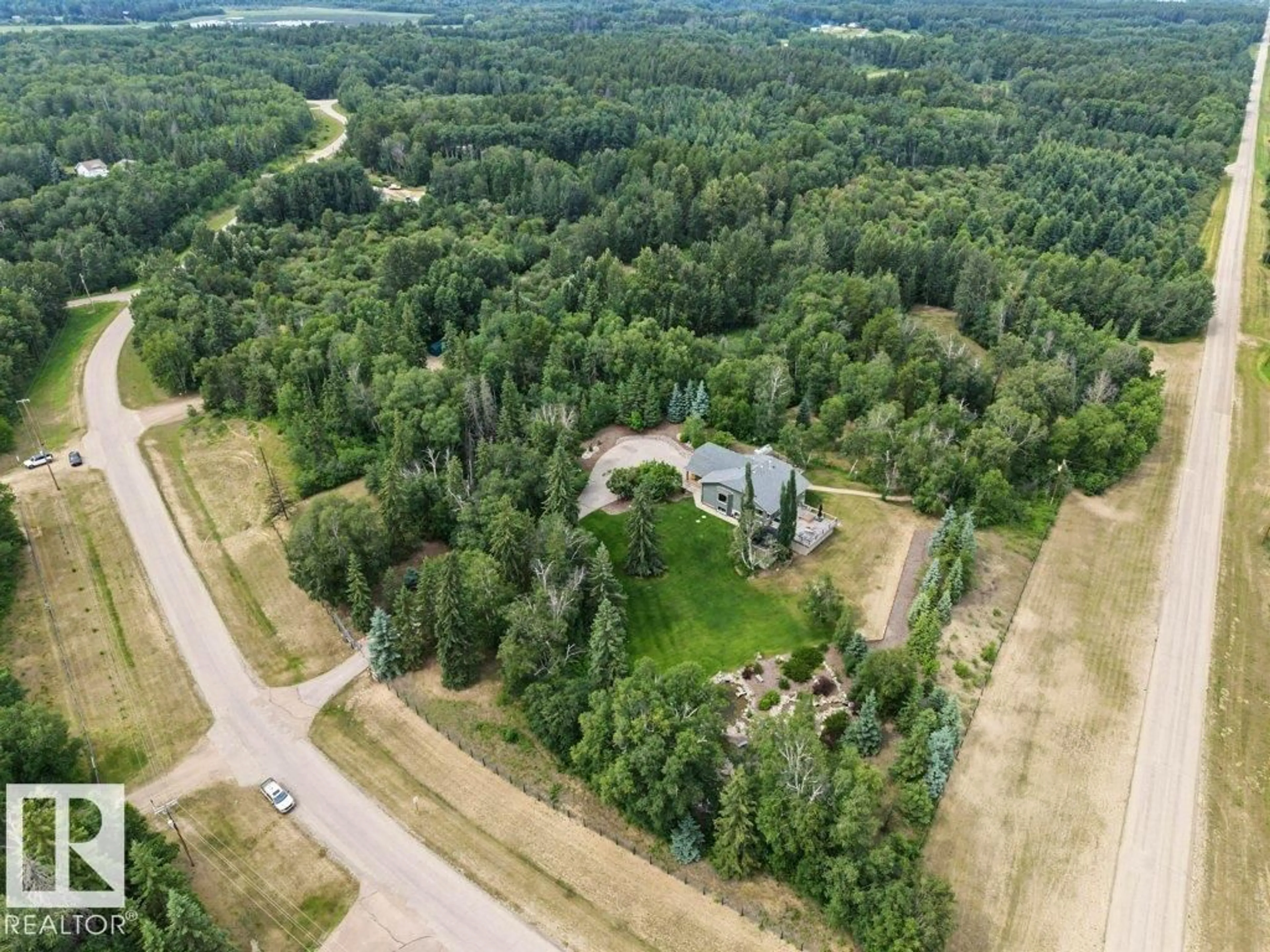 A pic from outside/outdoor area/front of a property/back of a property/a pic from drone, forest/trees view for #2 - 51124 RGE ROAD 264, Rural Parkland County Alberta T7Y1E8