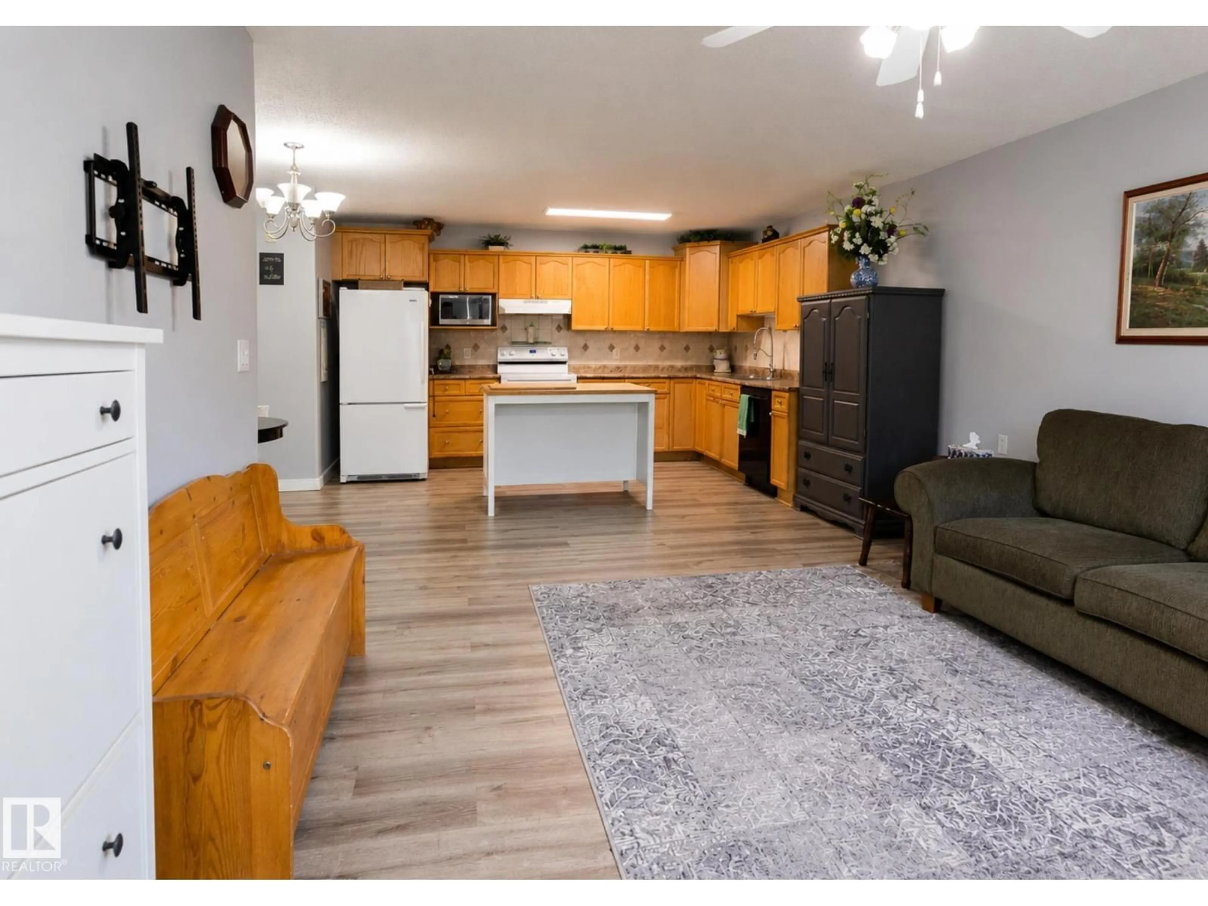Open concept kitchen, wood/laminate floor for #10 - 5501 PINE DR, Cherry Grove Alberta T0A0T0