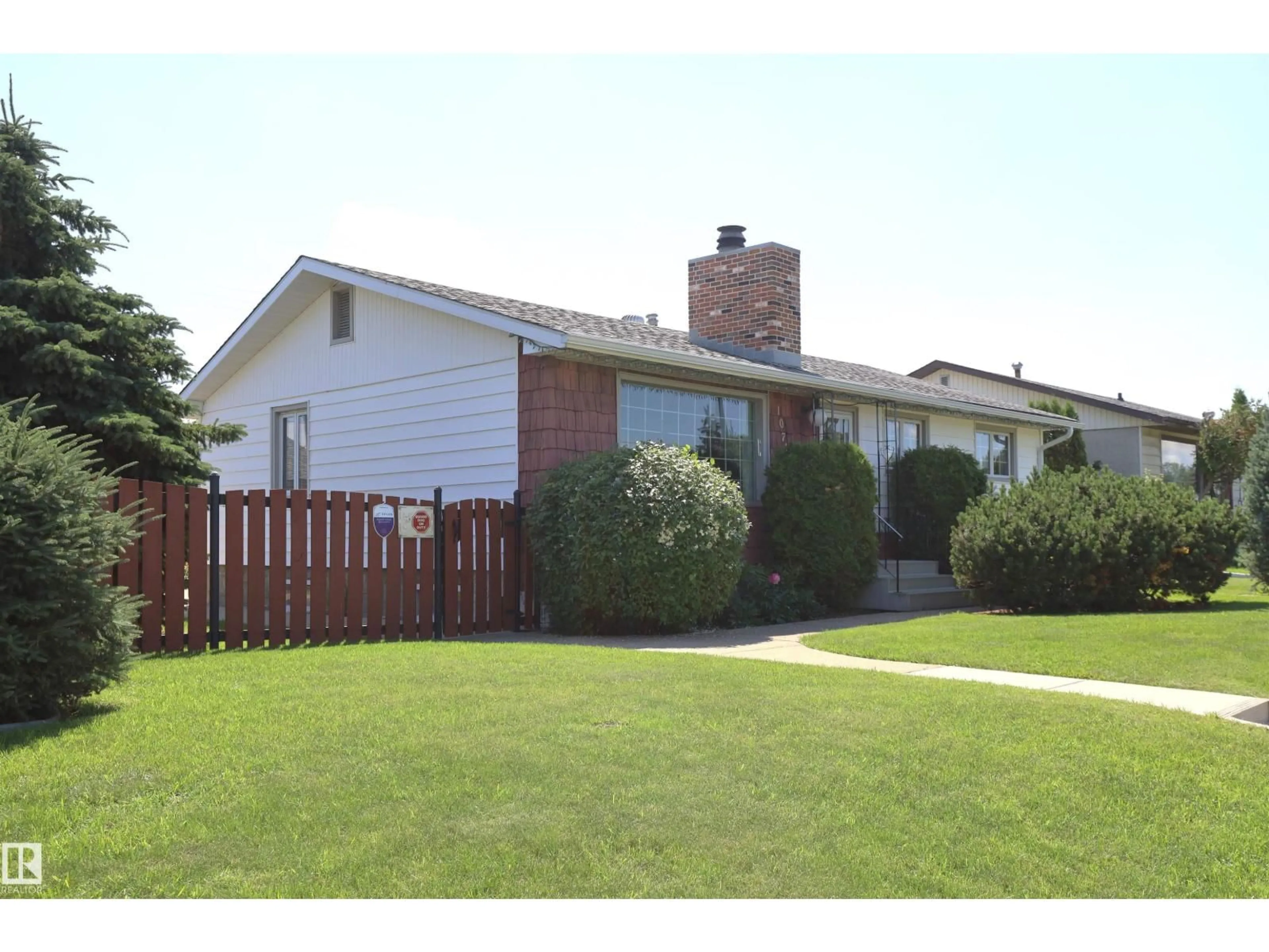 Home with vinyl exterior material, street for 10715 132 AV, Edmonton Alberta T5E0Z5