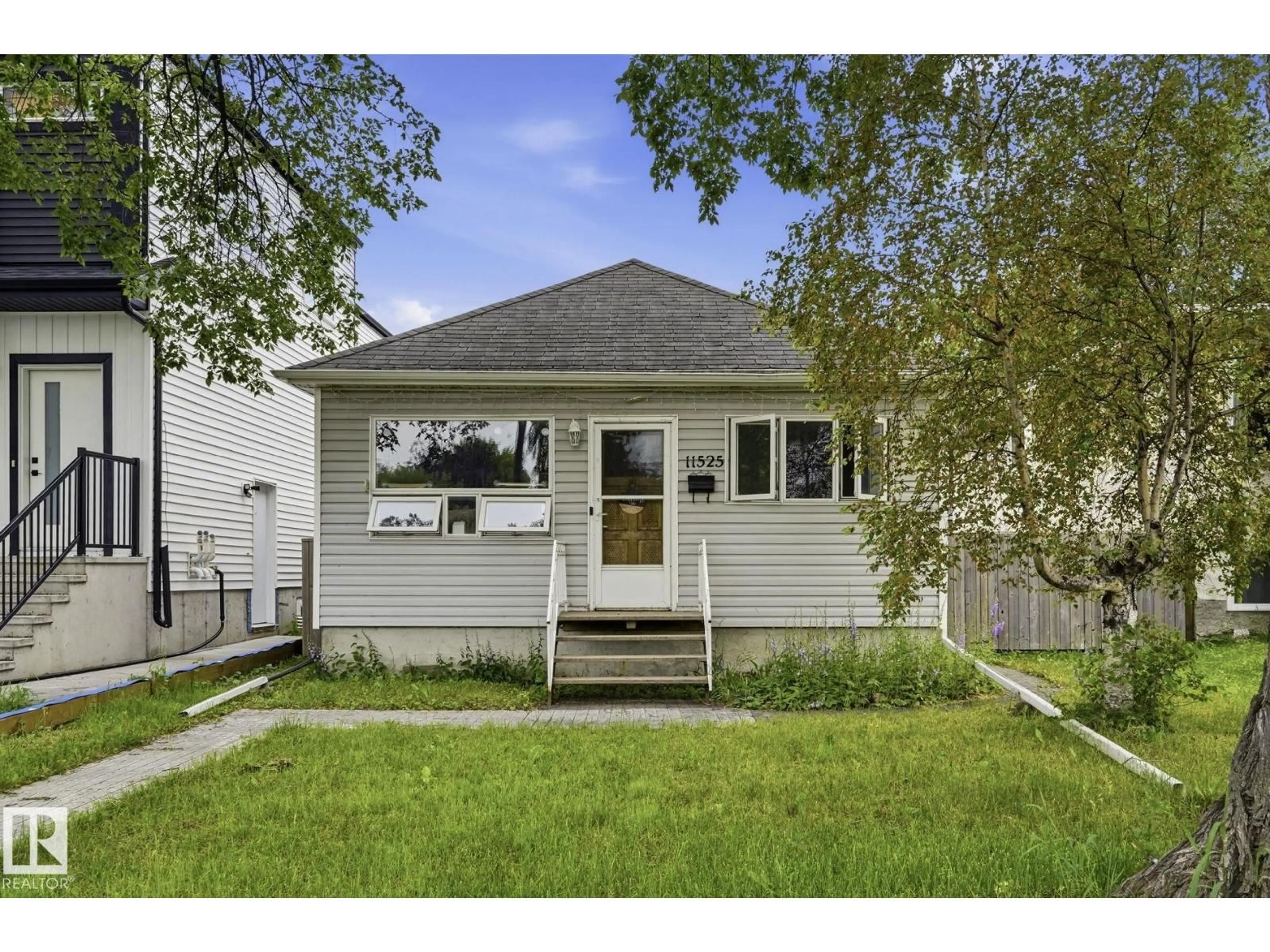 Home with vinyl exterior material, street for 11525 129 AV, Edmonton Alberta T5E0M4