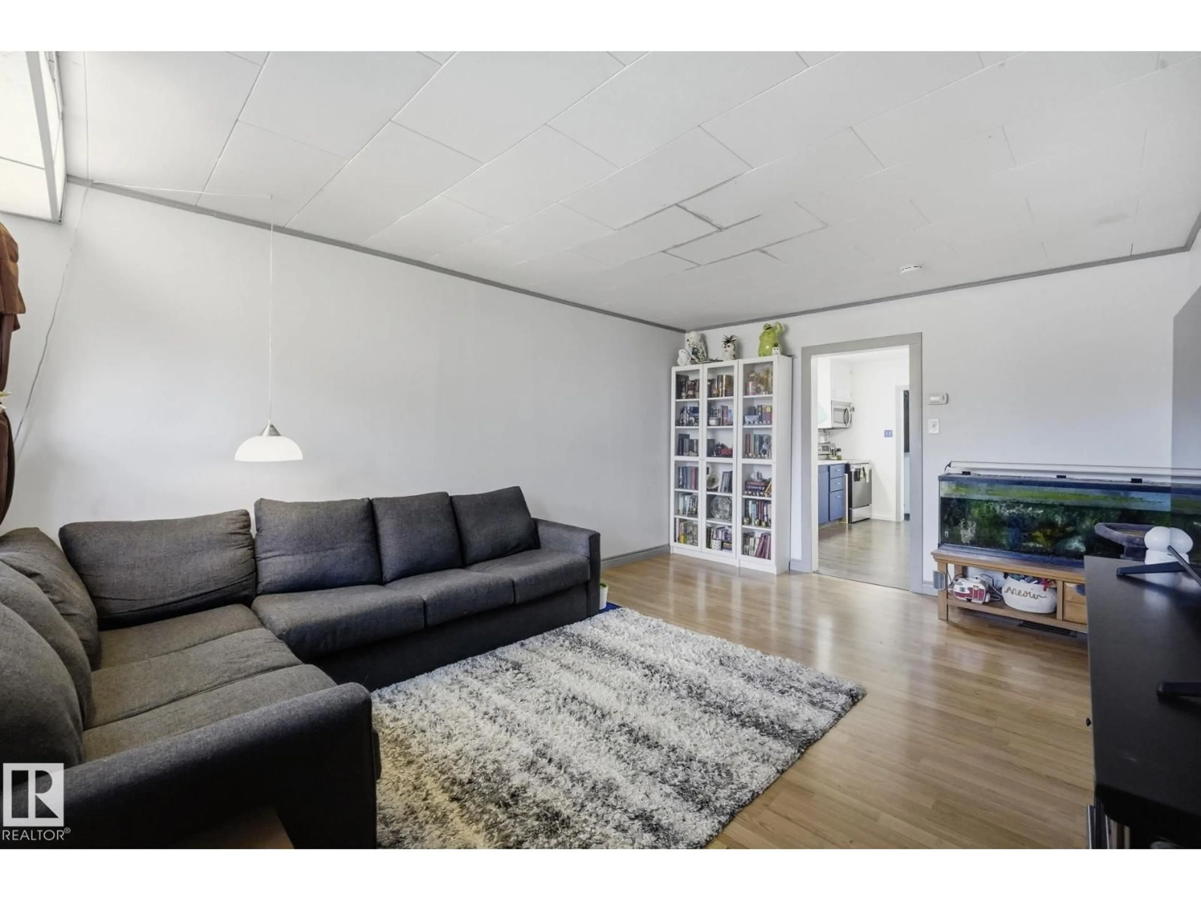 Living room with furniture, wood/laminate floor for 11525 129 AV, Edmonton Alberta T5E0M4