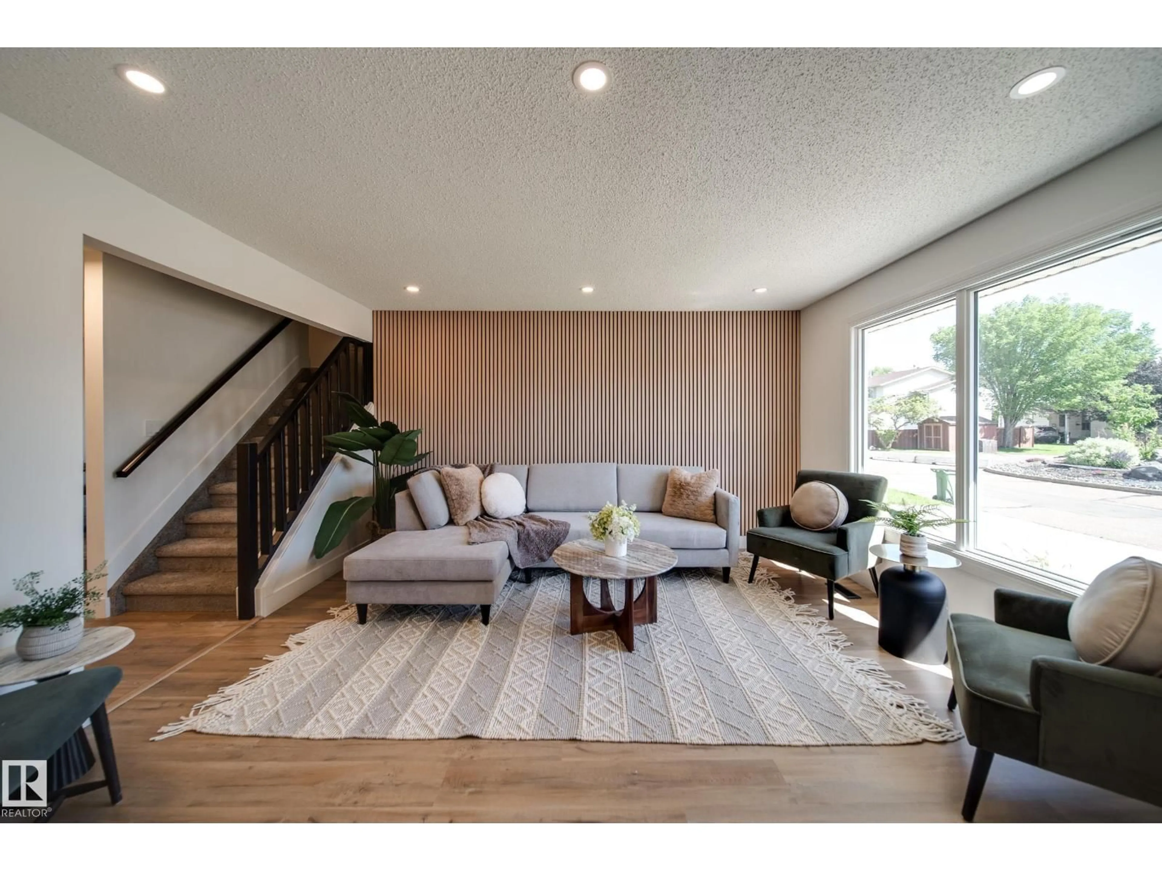 Living room with furniture, wood/laminate floor for 10343 172 AV, Edmonton Alberta T5X5C2