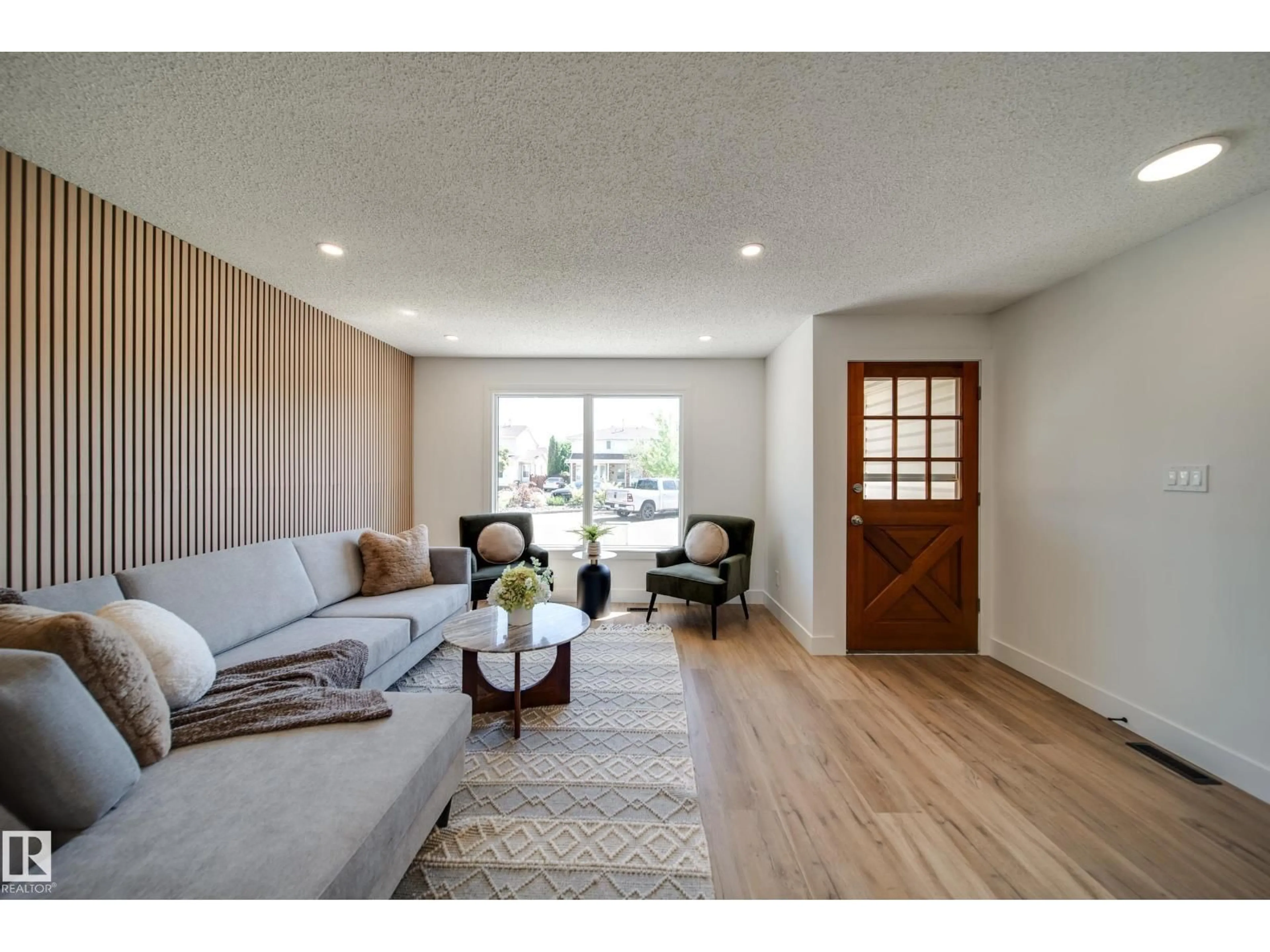 Living room with furniture, wood/laminate floor for 10343 172 AV, Edmonton Alberta T5X5C2