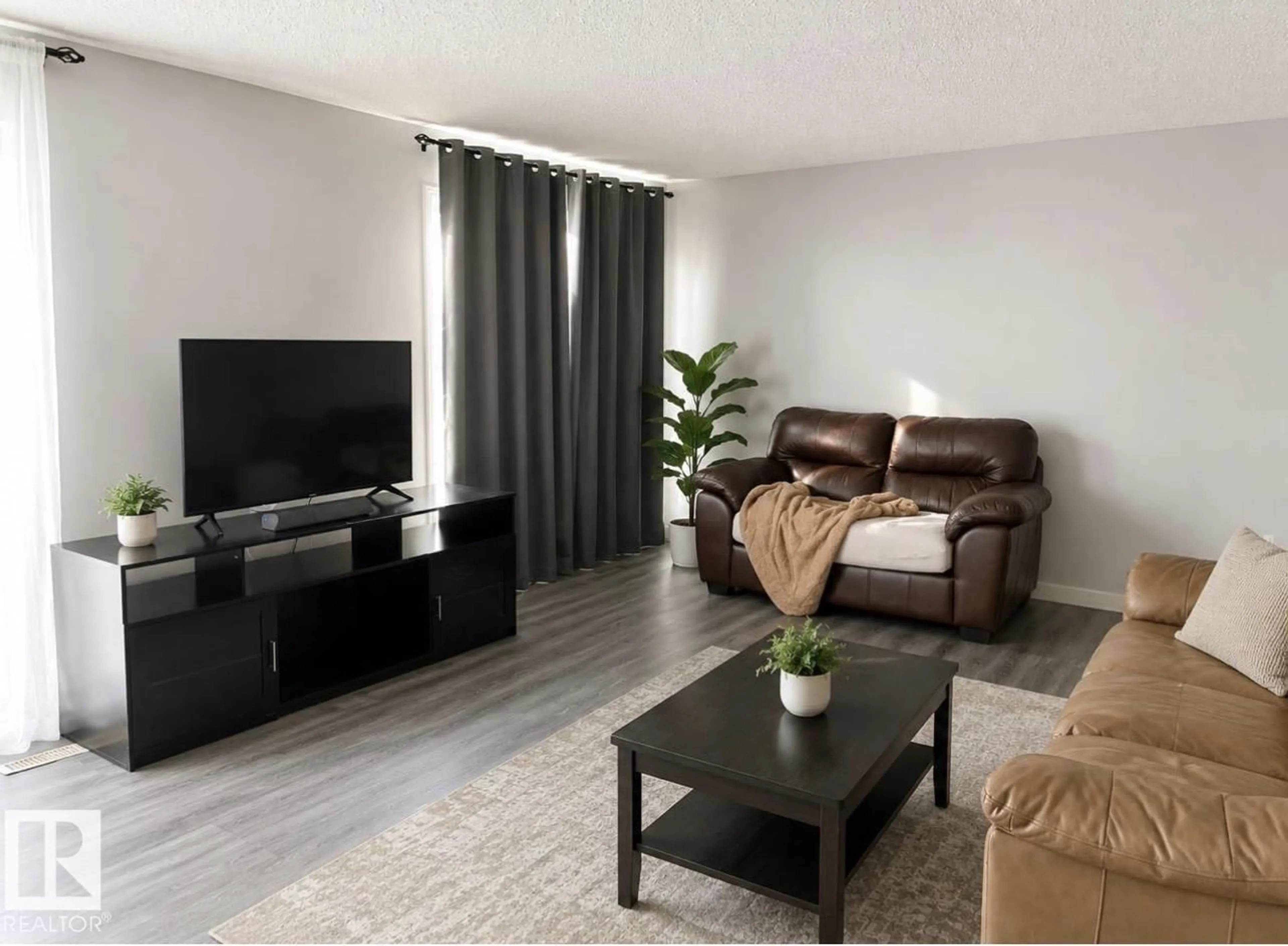 Living room with furniture, wood/laminate floor for 3221 132A AV, Edmonton Alberta T5A3K4