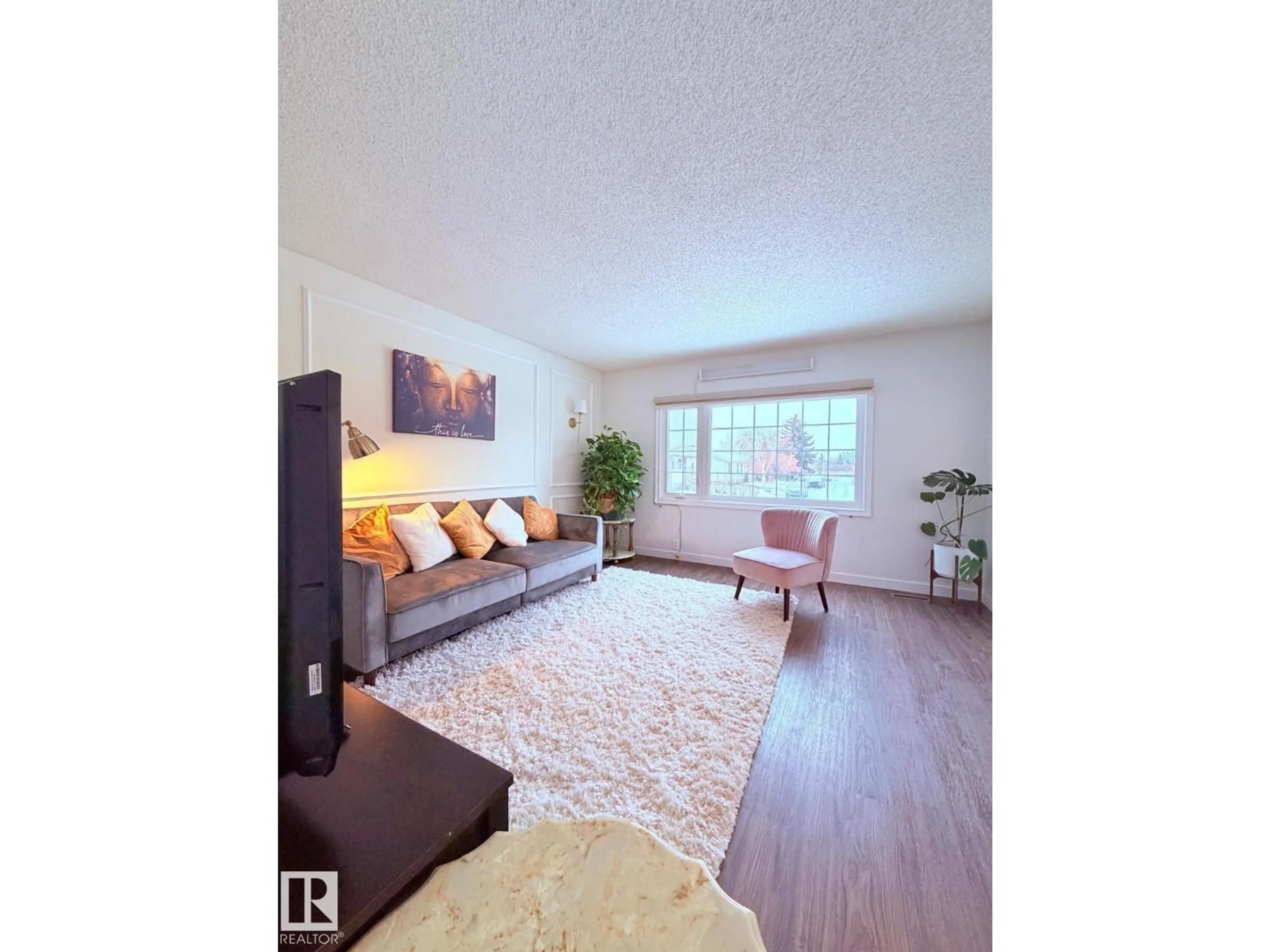 Living room with furniture, wood/laminate floor for 5303 21 AV, Edmonton Alberta T6L5G5