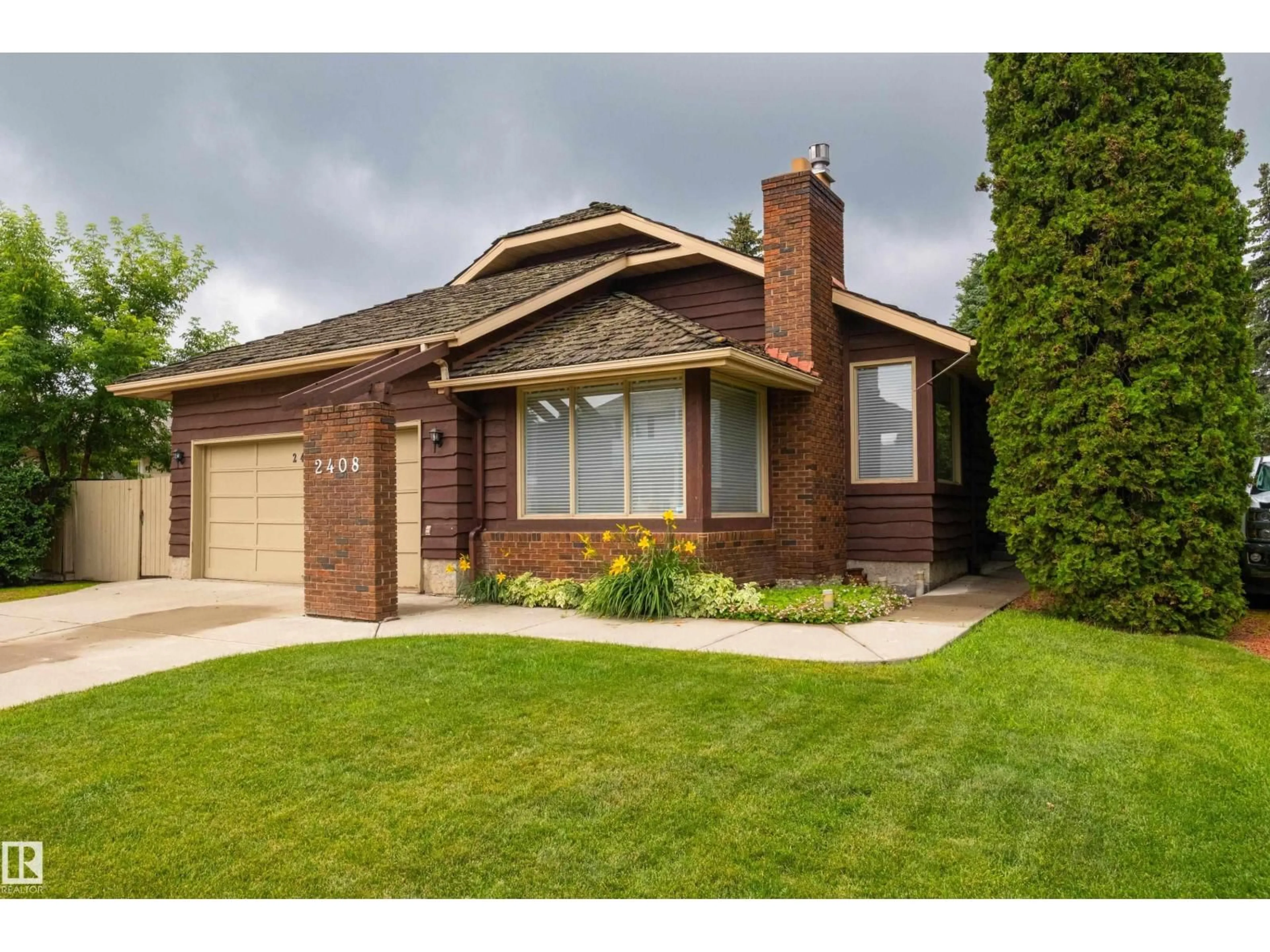 Home with brick exterior material, street for NW - 2408 115 ST, Edmonton Alberta T6J3S1