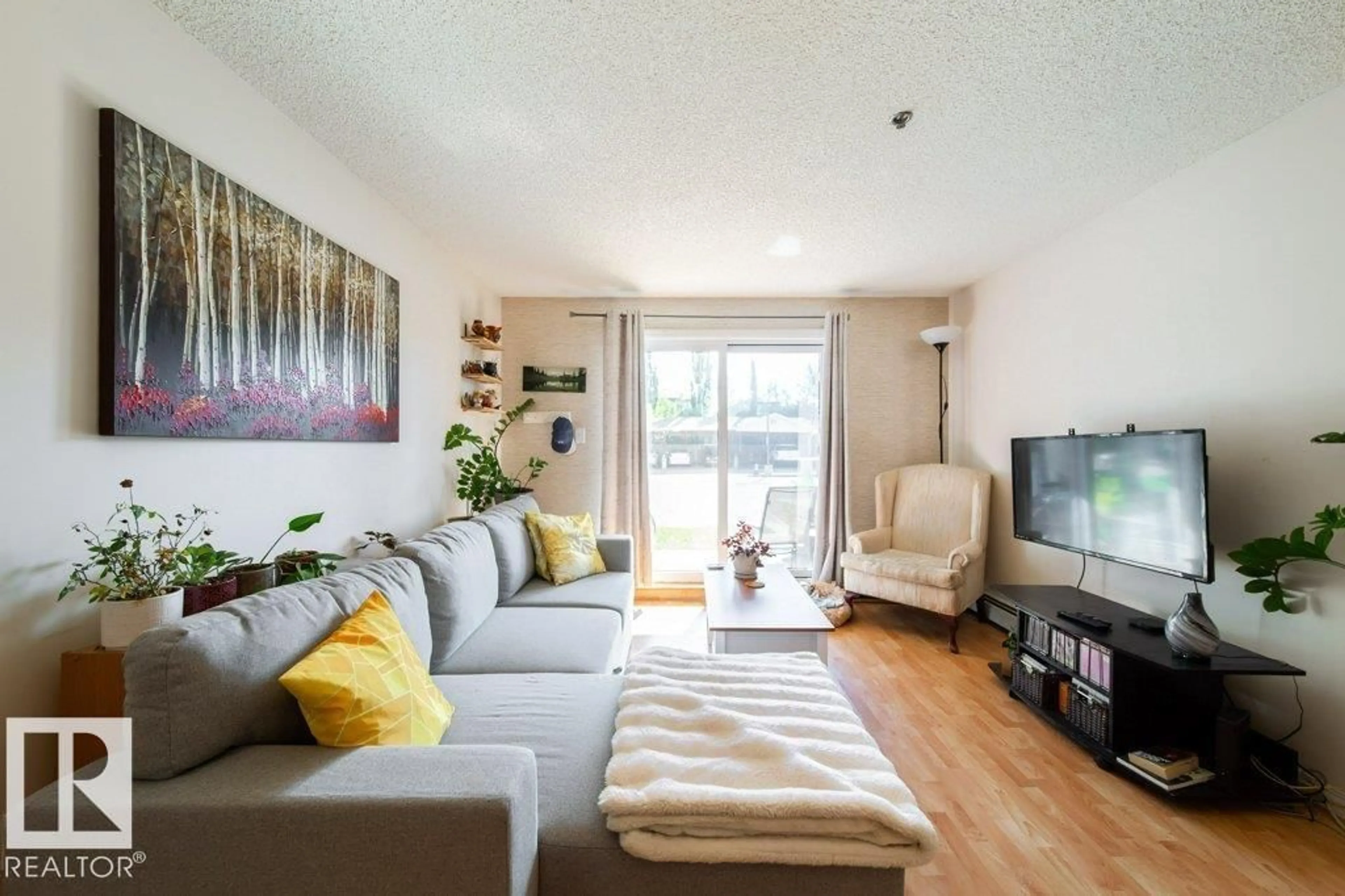 Living room with furniture, wood/laminate floor for #118 - 2305 35A AV, Edmonton Alberta T6T1Z2