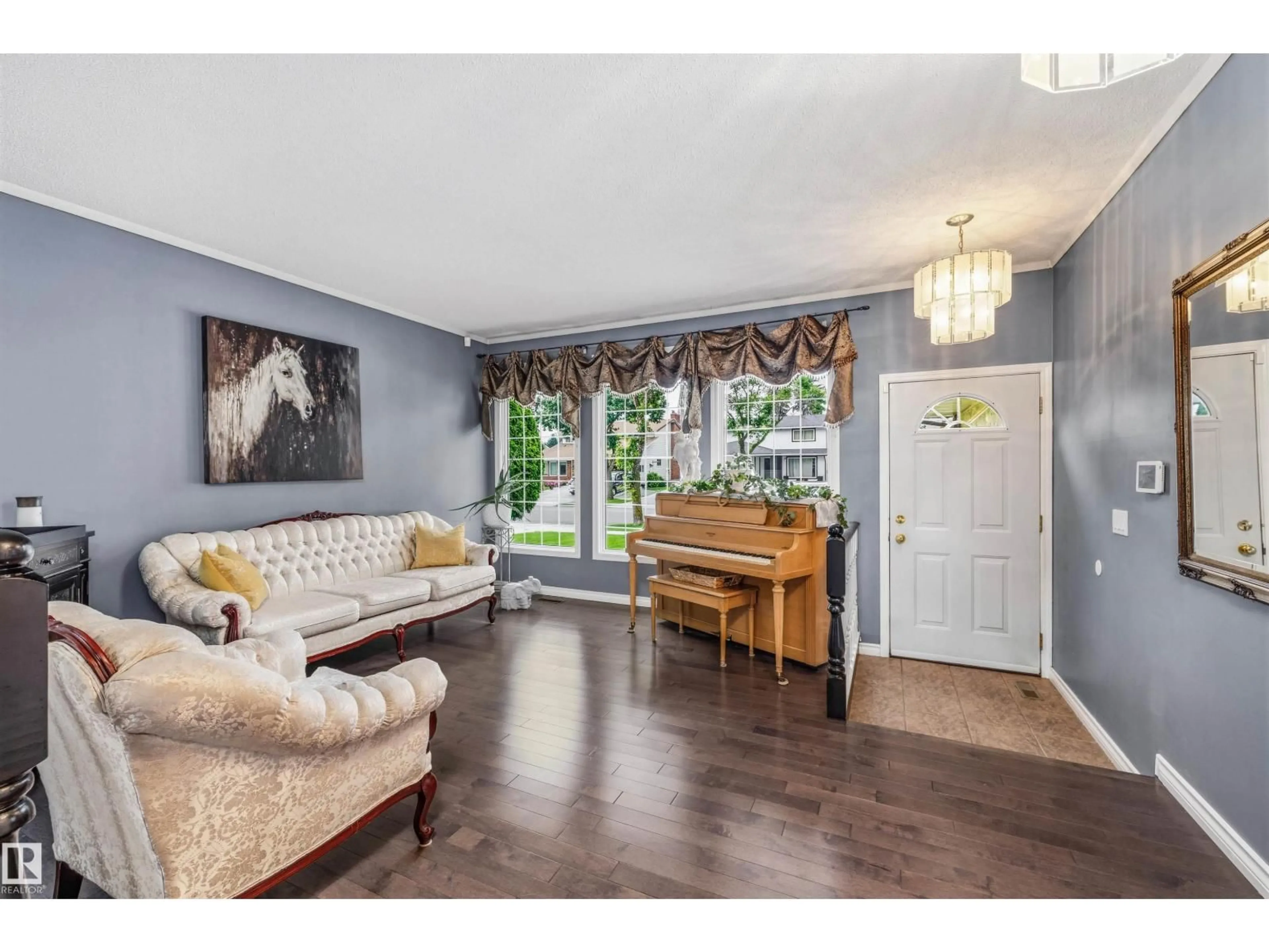 Living room with furniture, wood/laminate floor for NW - 15915 112 ST, Edmonton Alberta T5X4S7