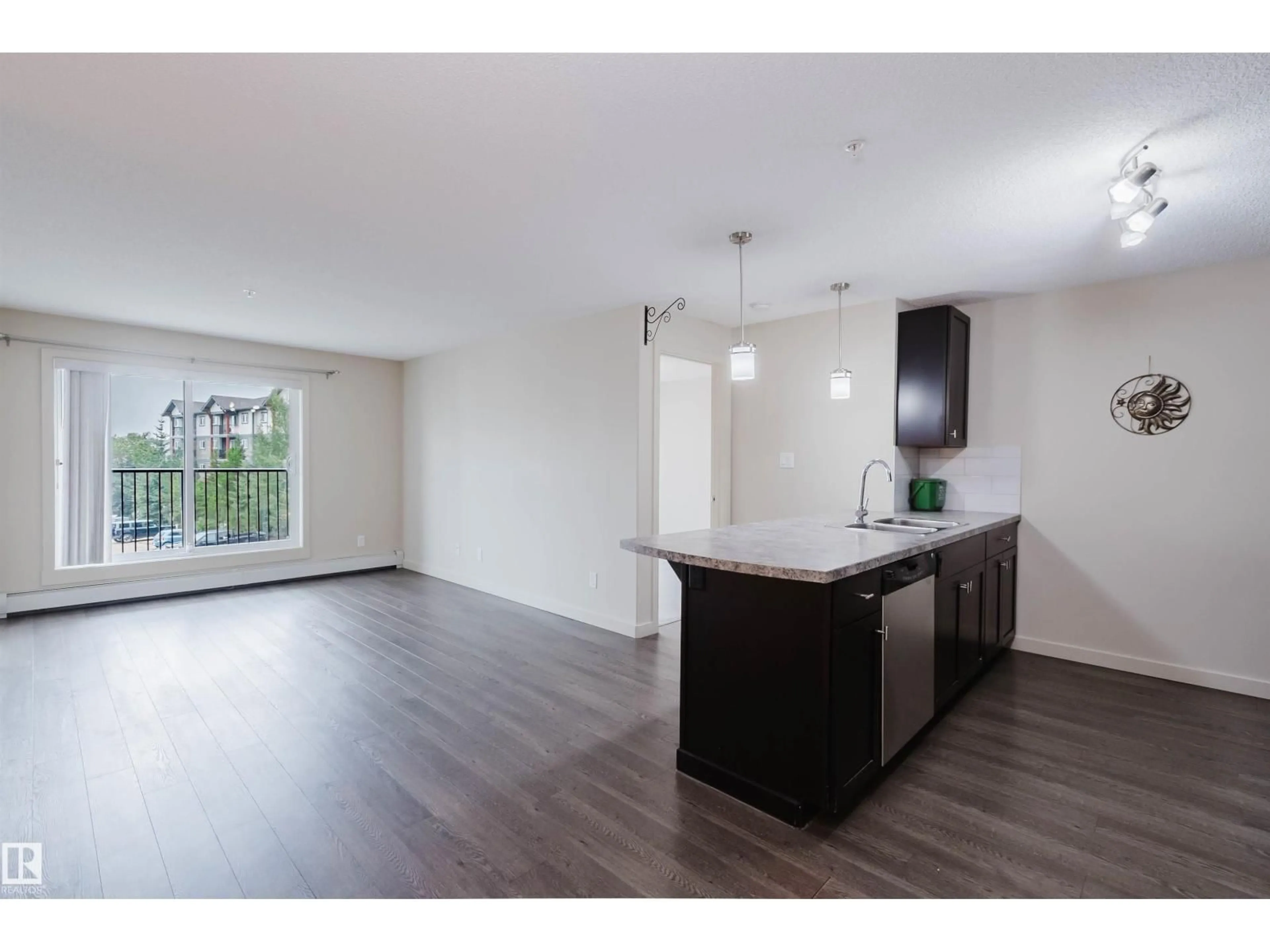Open concept kitchen, wood/laminate floor for 304 - 6084 STANTON DR, Edmonton Alberta T6X0Z4