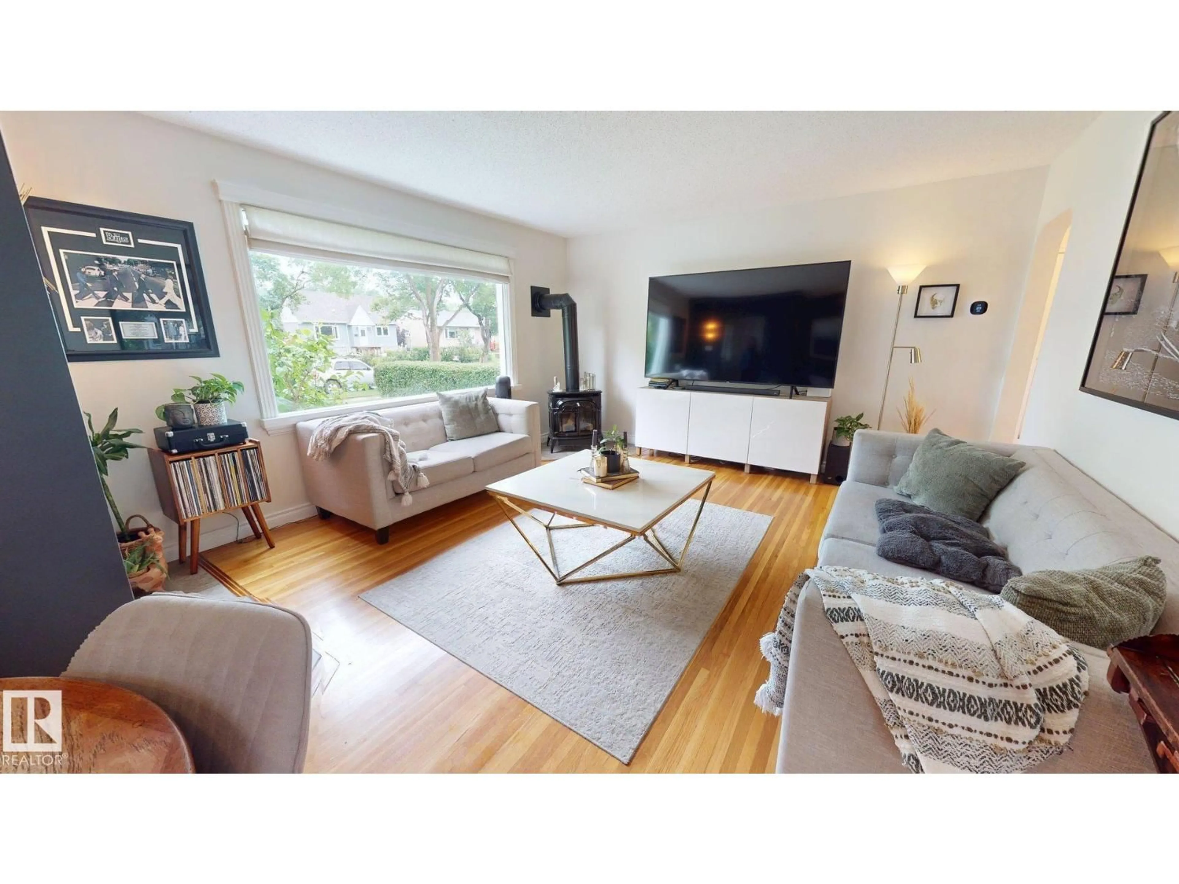 Living room with furniture, wood/laminate floor for 7727 77 AV, Edmonton Alberta T6C0K6