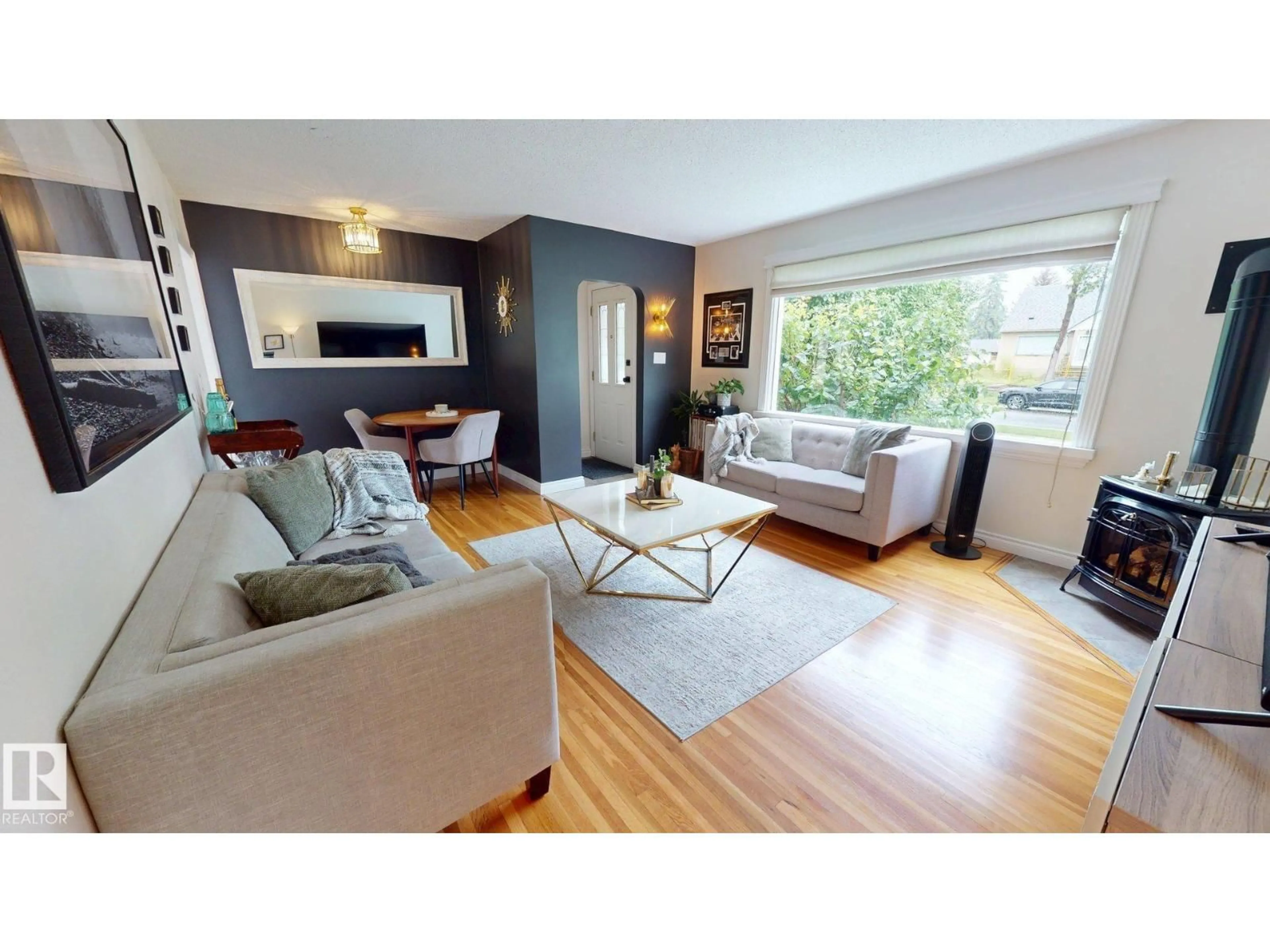 Living room with furniture, wood/laminate floor for 7727 77 AV, Edmonton Alberta T6C0K6