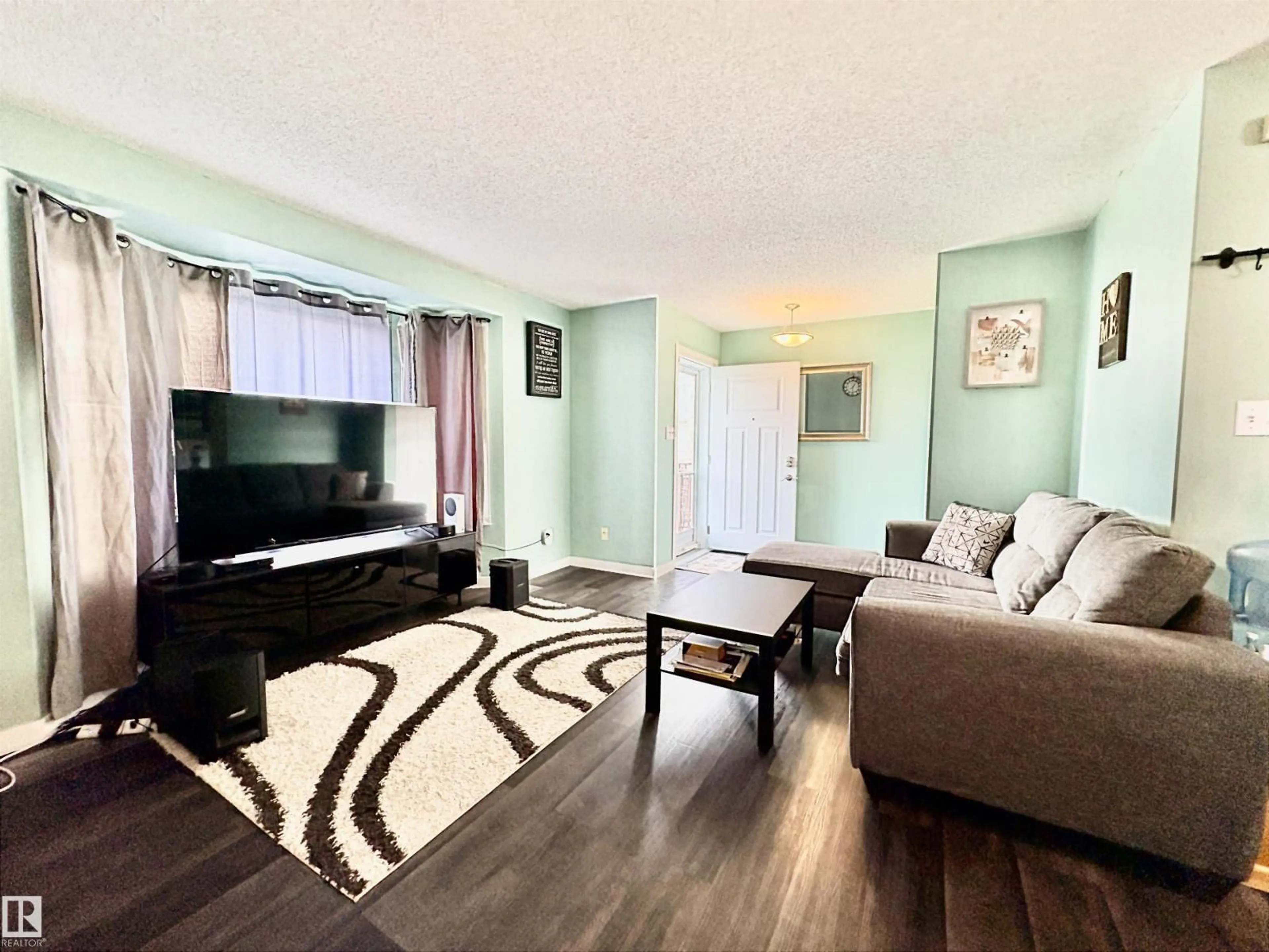 Living room with furniture, wood/laminate floor for 325 KLINE CR, Edmonton Alberta T6L6K8