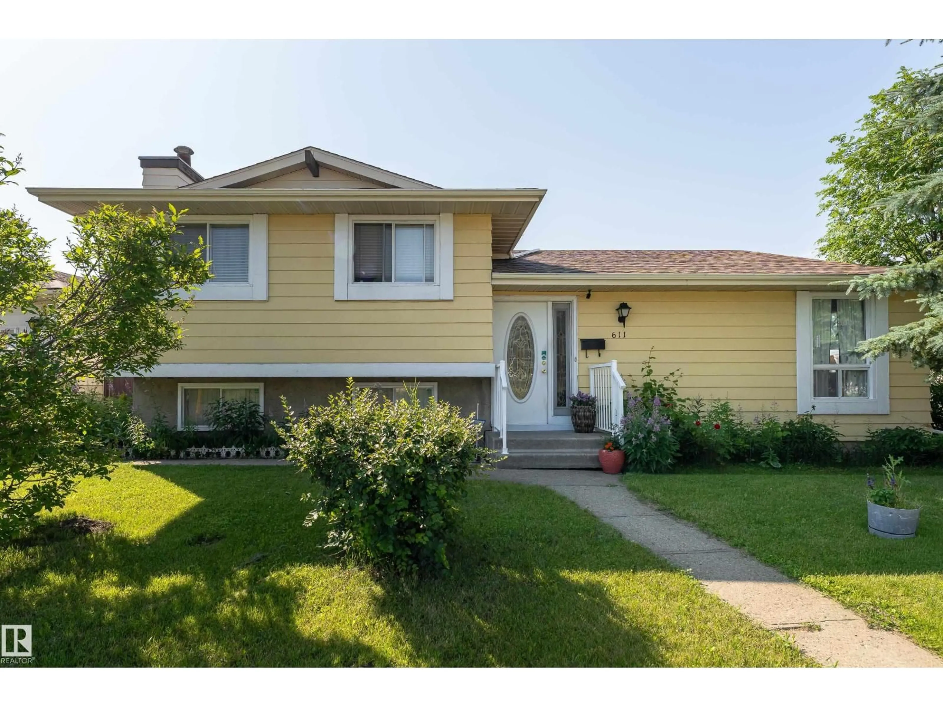 Home with vinyl exterior material, street for 611 KIRKNESS RD, Edmonton Alberta T5Y2L5