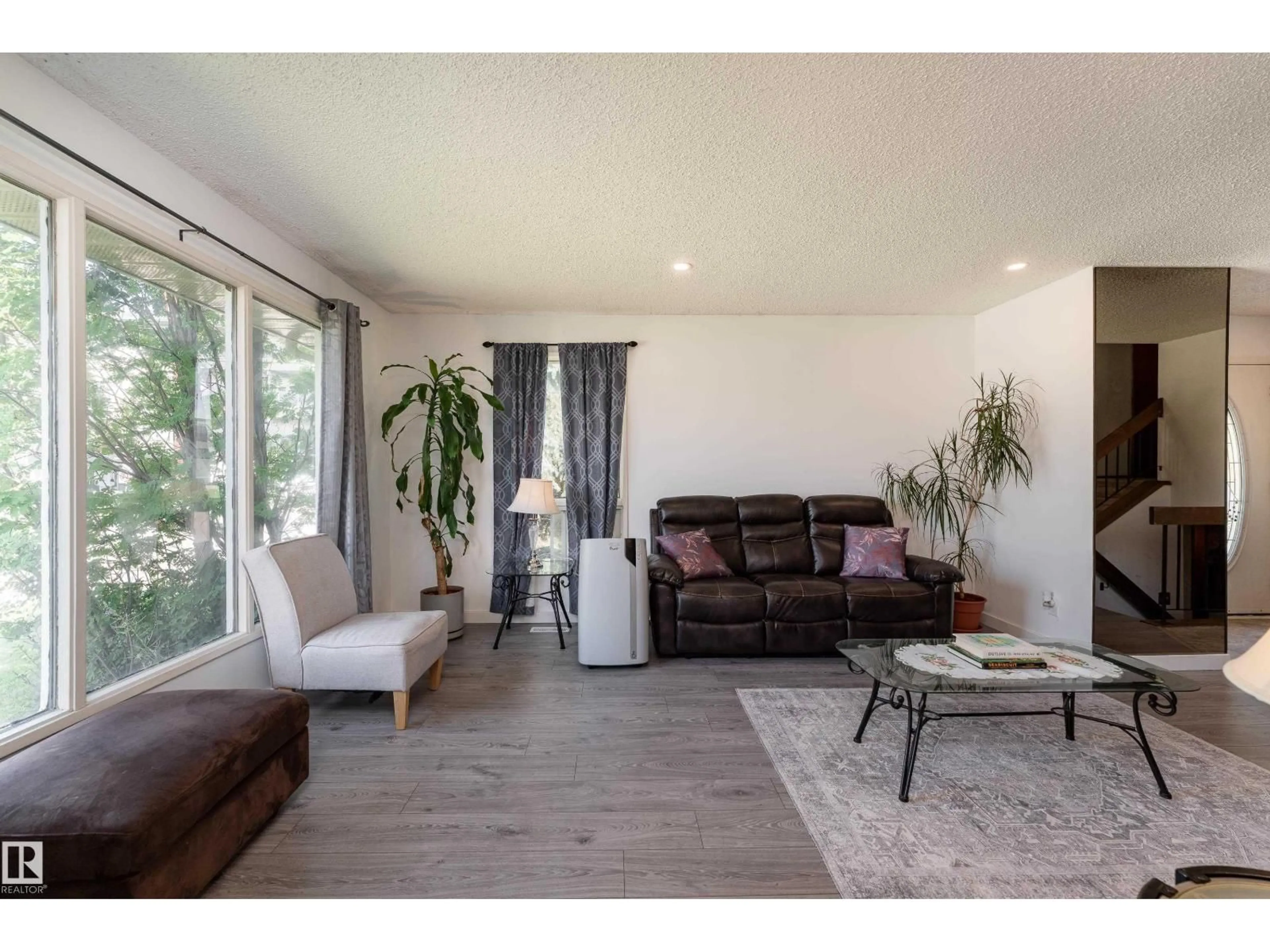 Living room with furniture, wood/laminate floor for 611 KIRKNESS RD, Edmonton Alberta T5Y2L5