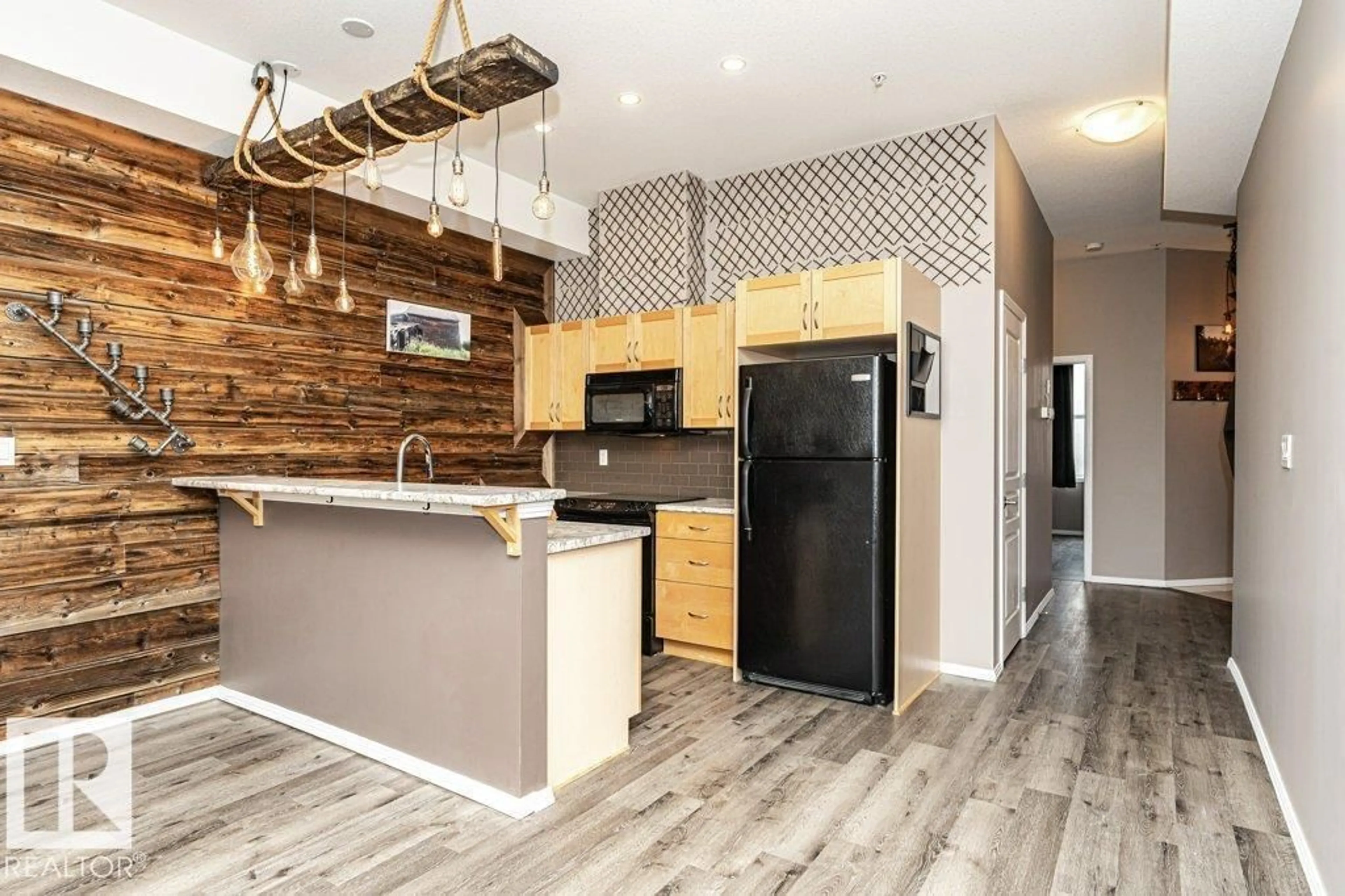 Open concept kitchen, wood/laminate floor for #404 - 10531 117 ST, Edmonton Alberta T5H0A8