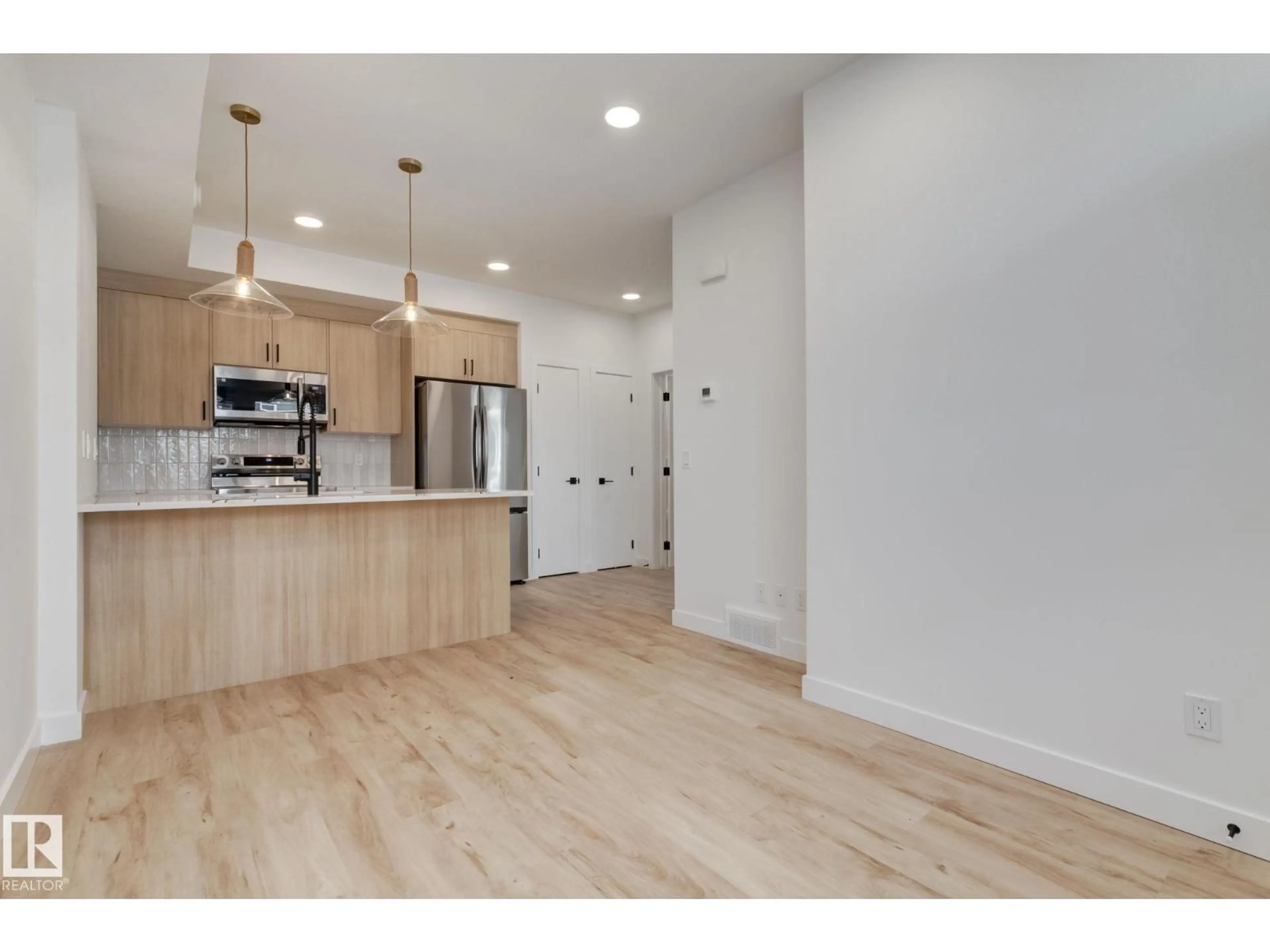 Open concept kitchen, wood/laminate floor for 16231 19 AV, Edmonton Alberta T6W5C6
