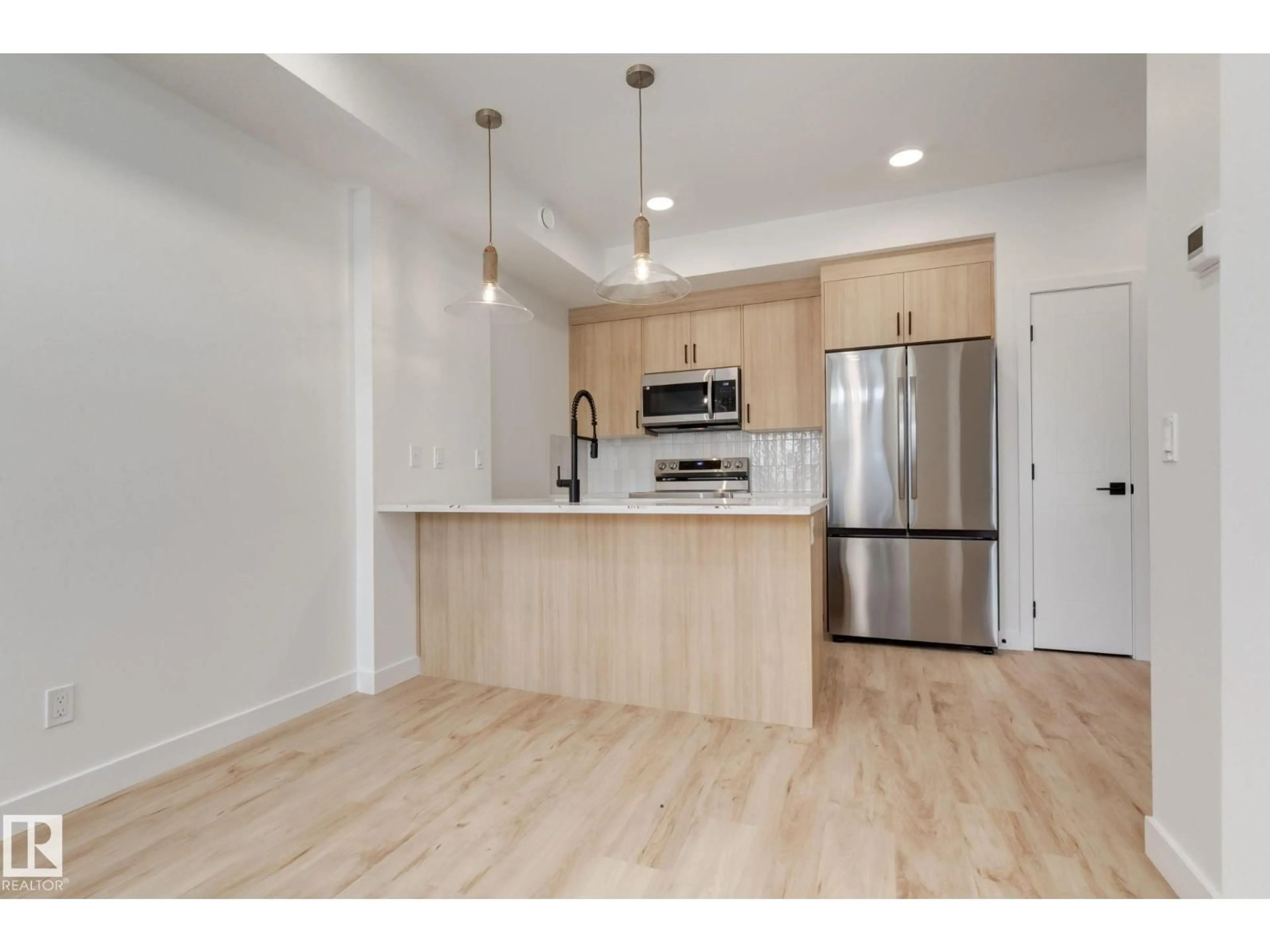 Open concept kitchen, wood/laminate floor for 16231 19 AV, Edmonton Alberta T6W5C6