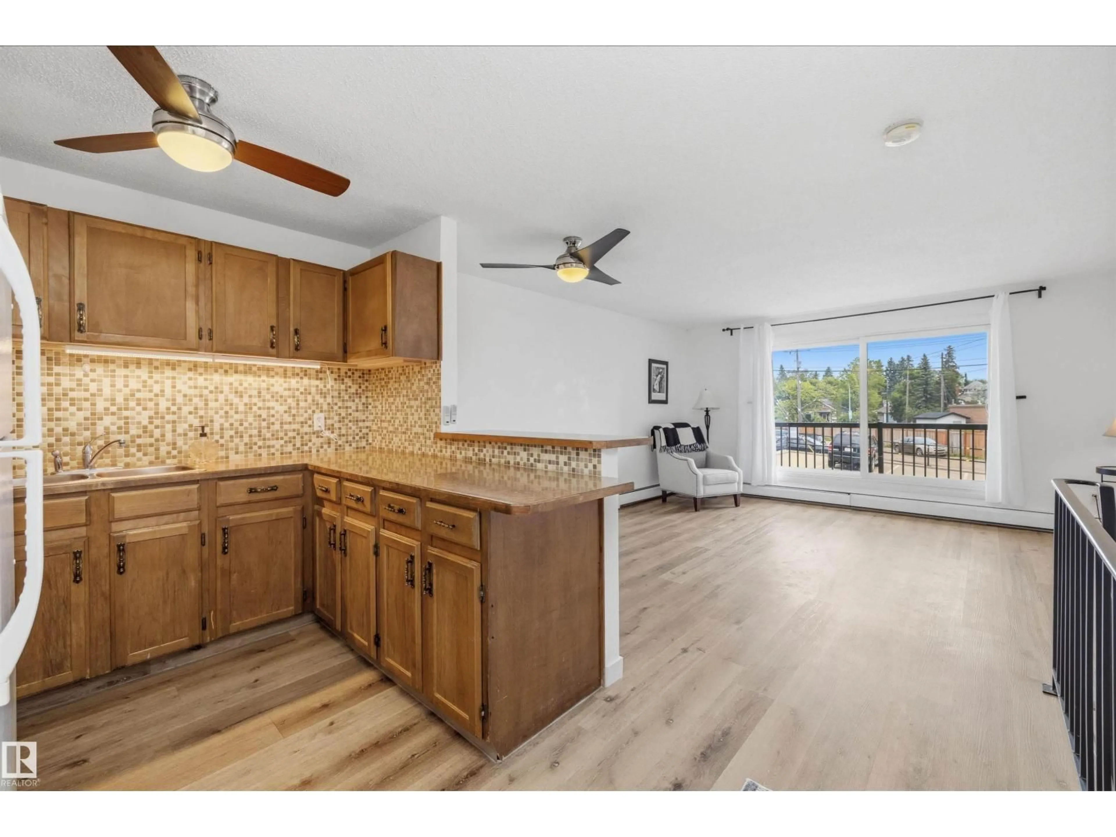 Open concept kitchen, wood/laminate floor for #8 - 10931 83 ST, Edmonton Alberta T5H1M2