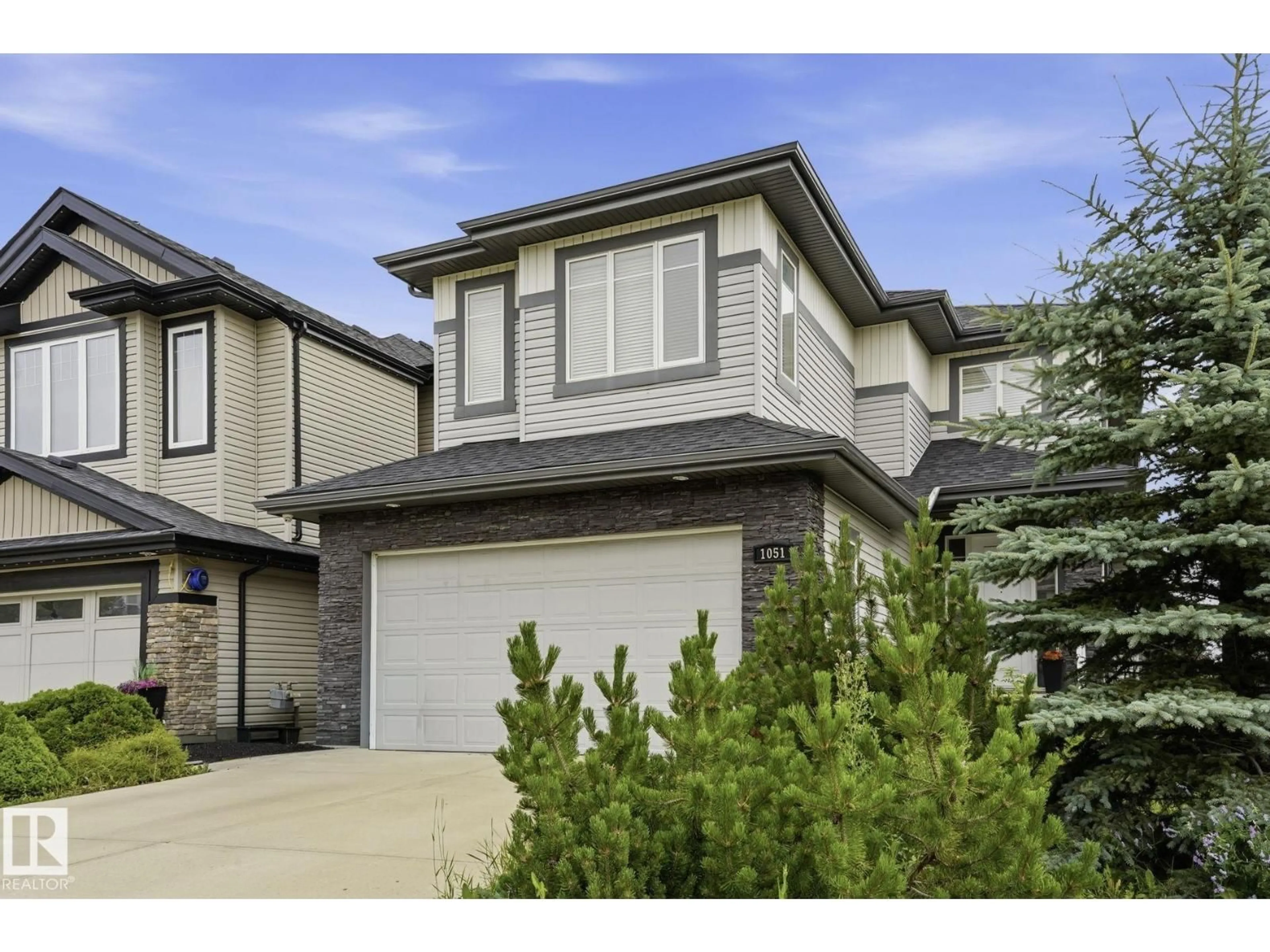 Home with vinyl exterior material, street for 1051 174 ST, Edmonton Alberta T6W1Z6