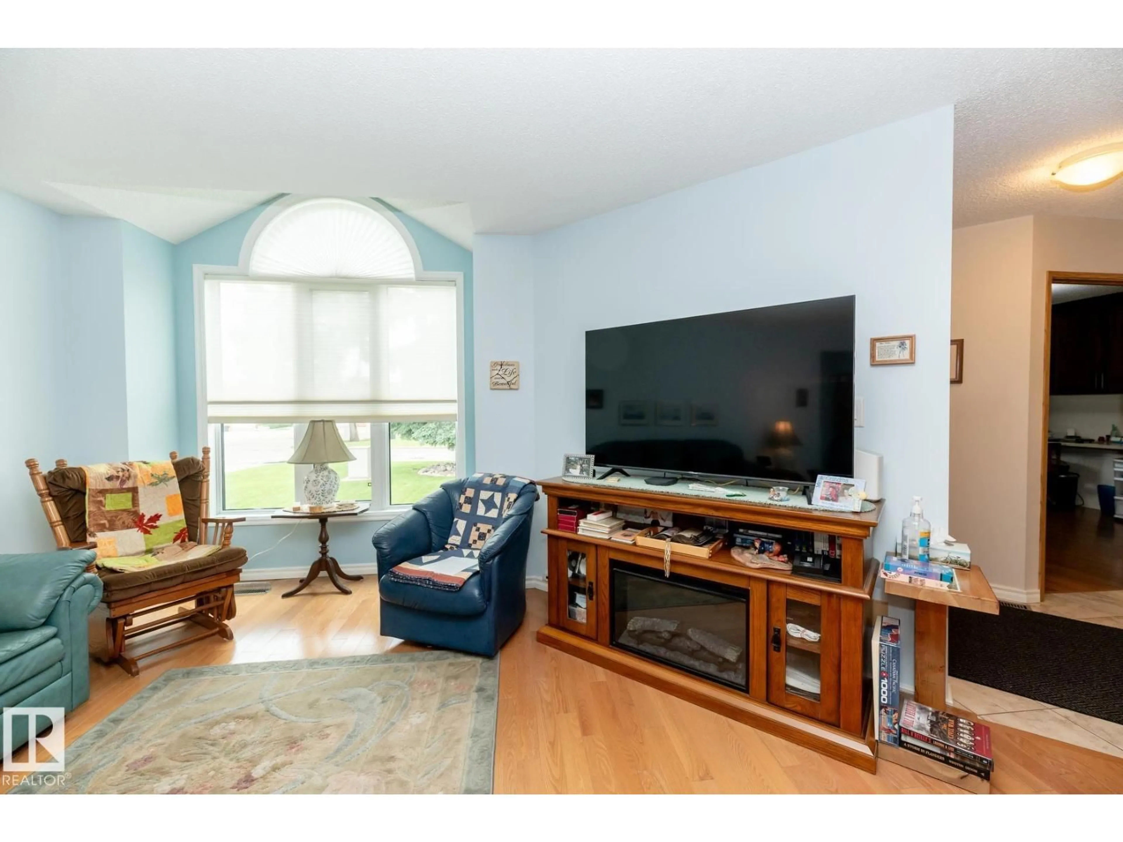 Living room with furniture, wood/laminate floor for 10860 25 AV, Edmonton Alberta T6J6N5