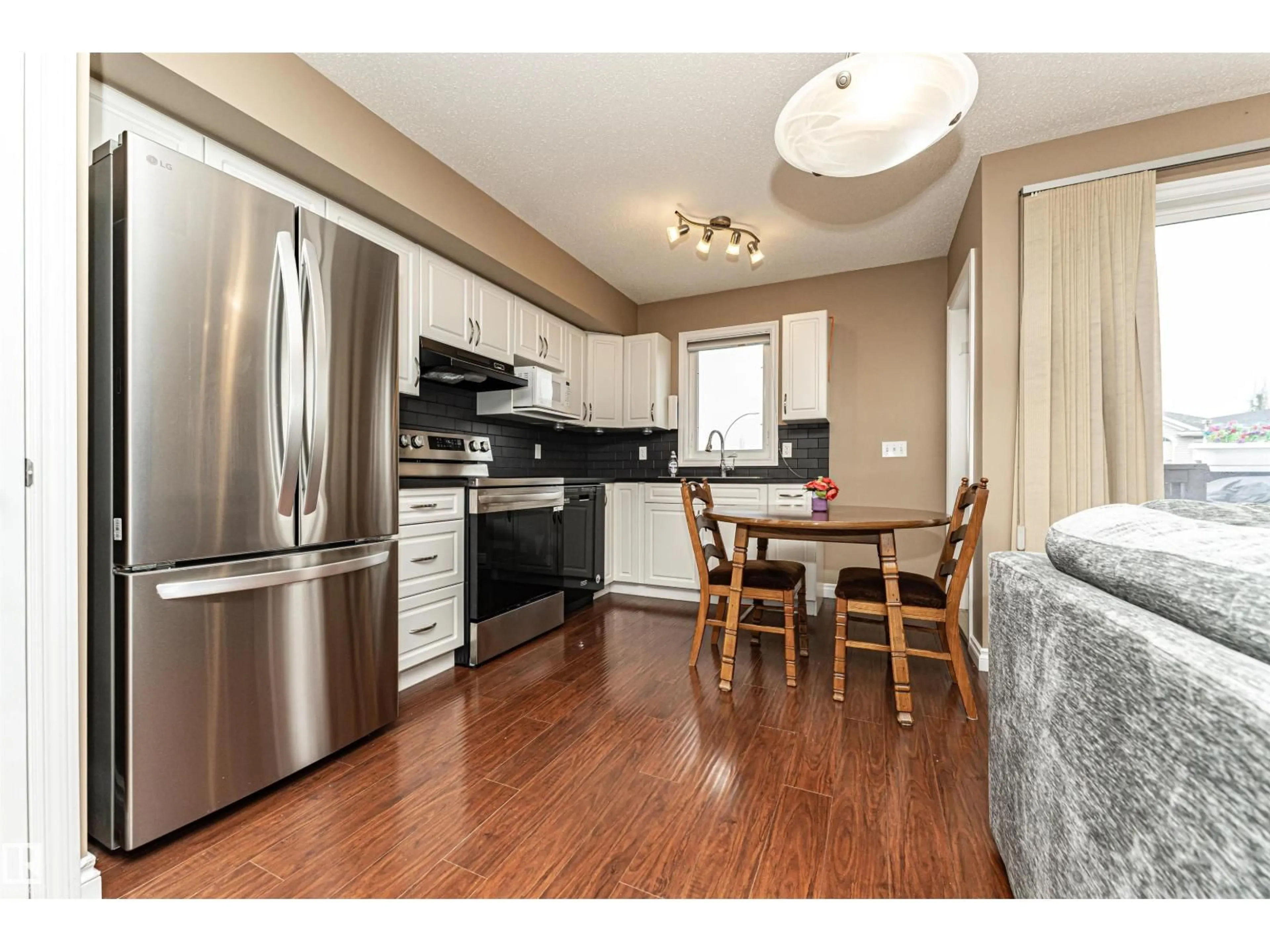 Open concept kitchen, wood/laminate floor for 44 171 BRINTNELL BV NW, Edmonton Alberta T5Y0C6