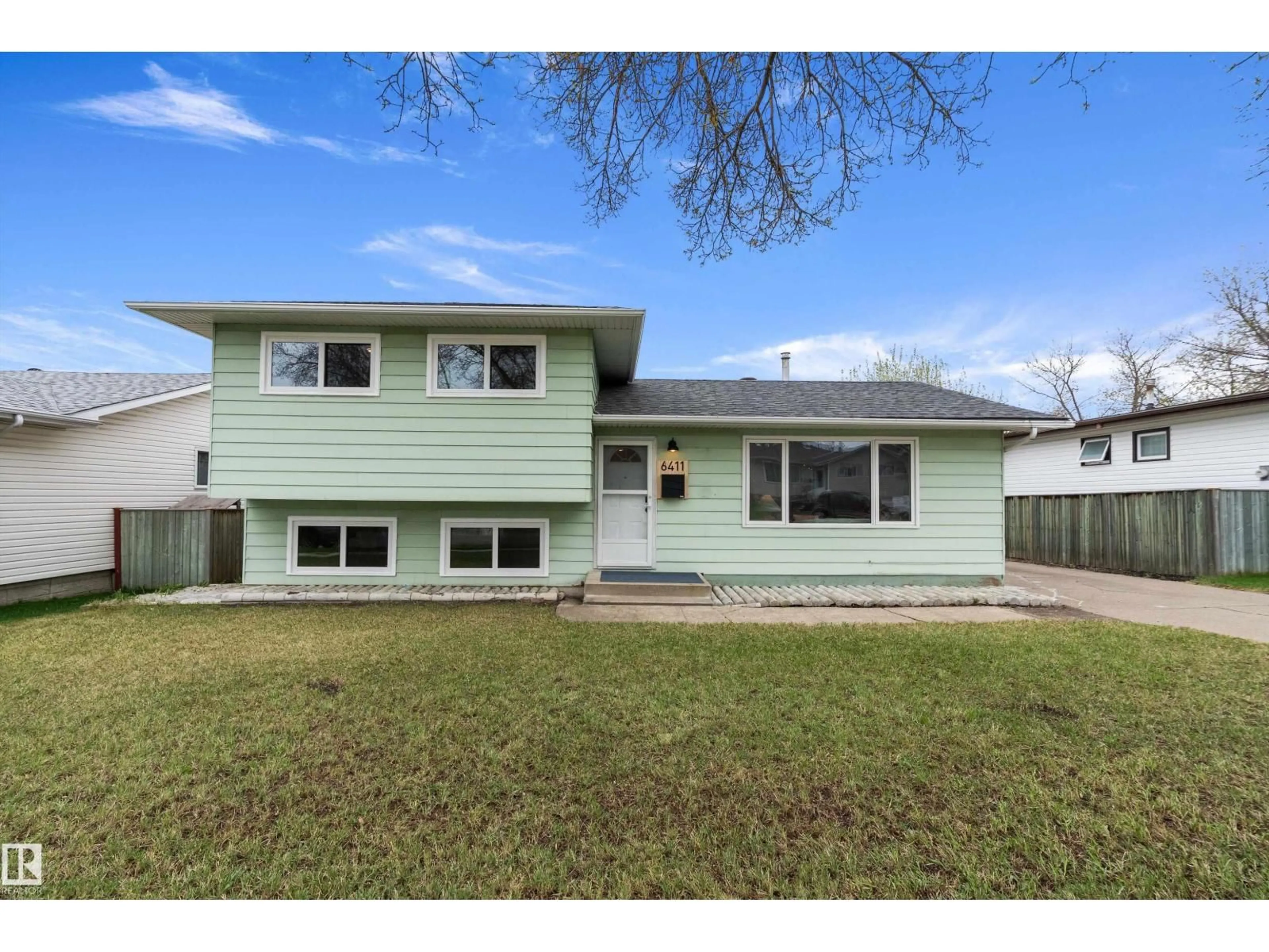 Home with vinyl exterior material, street for 6411 152A AV, Edmonton Alberta T5A1X9