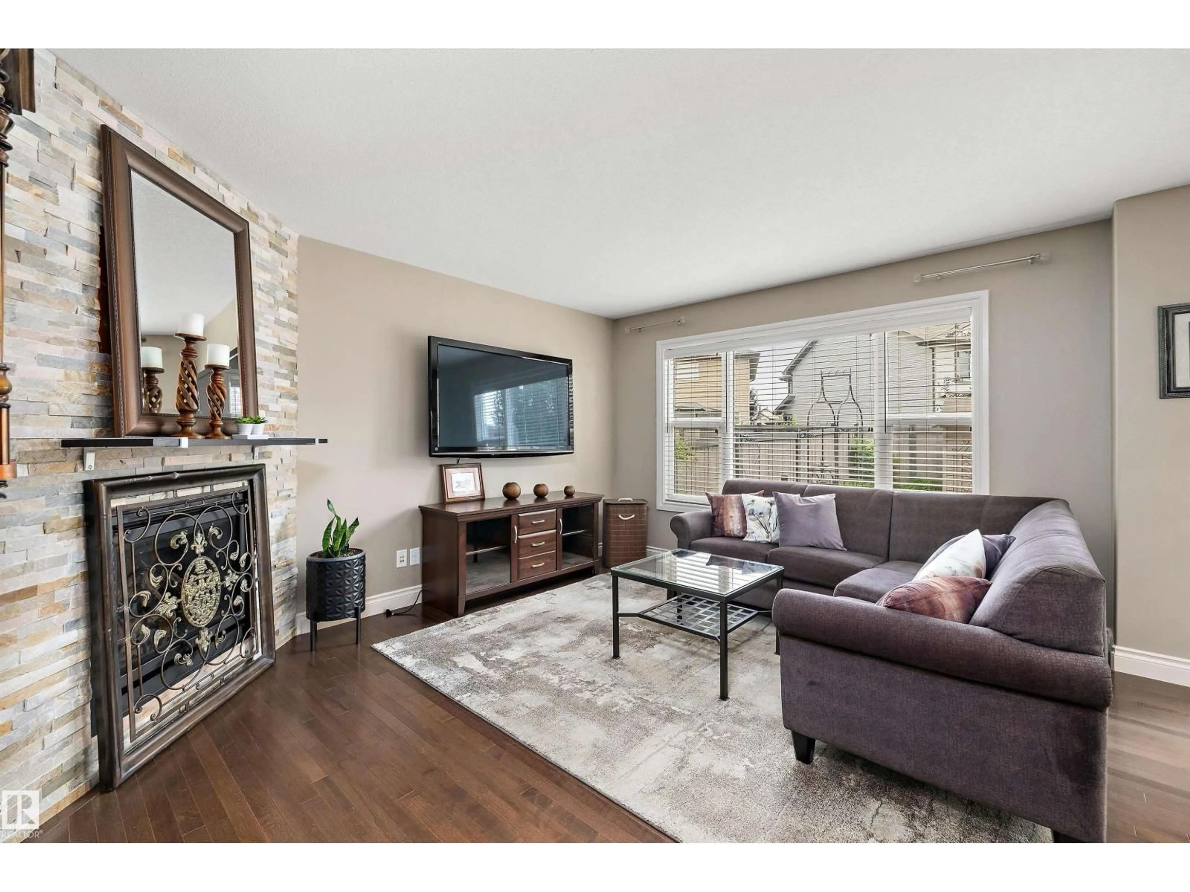Living room with furniture, wood/laminate floor for SW - 17332 6 AV, Edmonton Alberta T6W2A7