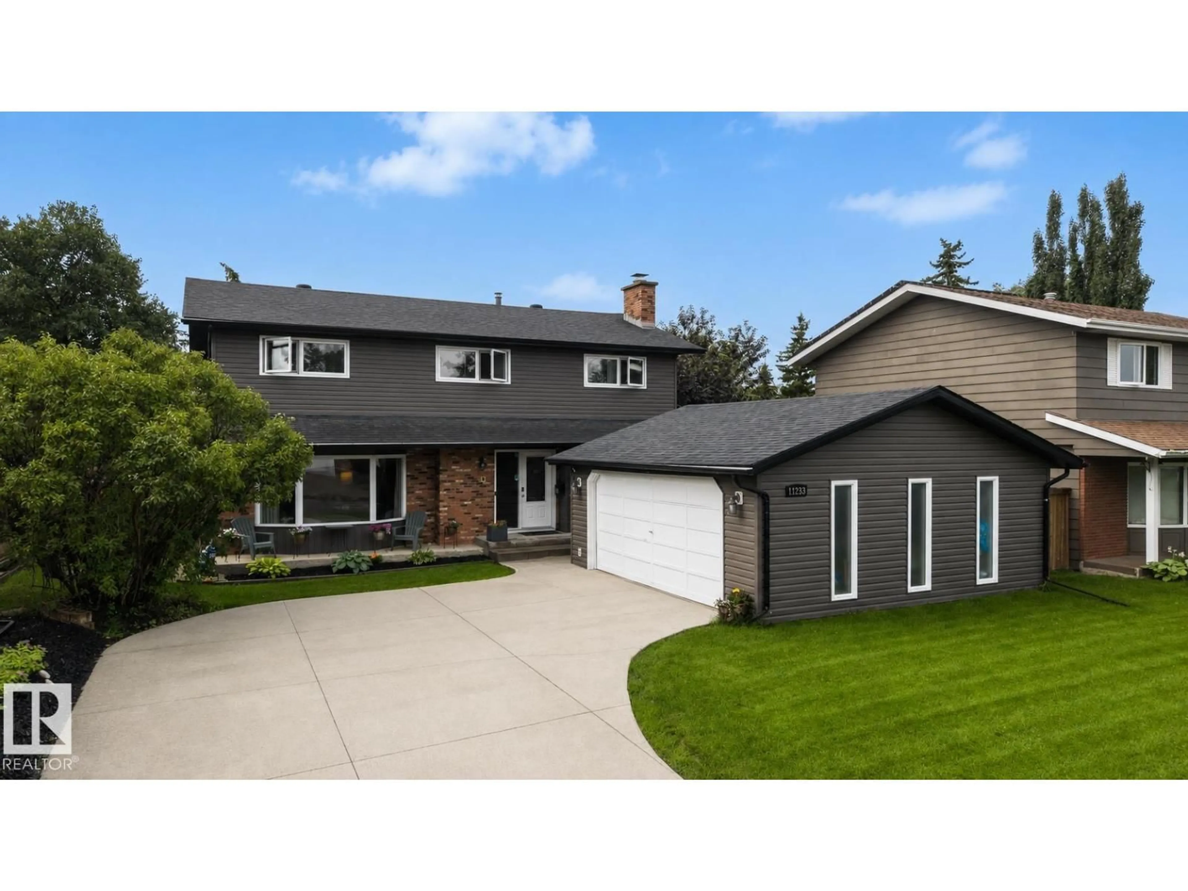 Home with vinyl exterior material, street for NW - 11233 34A AV, Edmonton Alberta T6J3M4