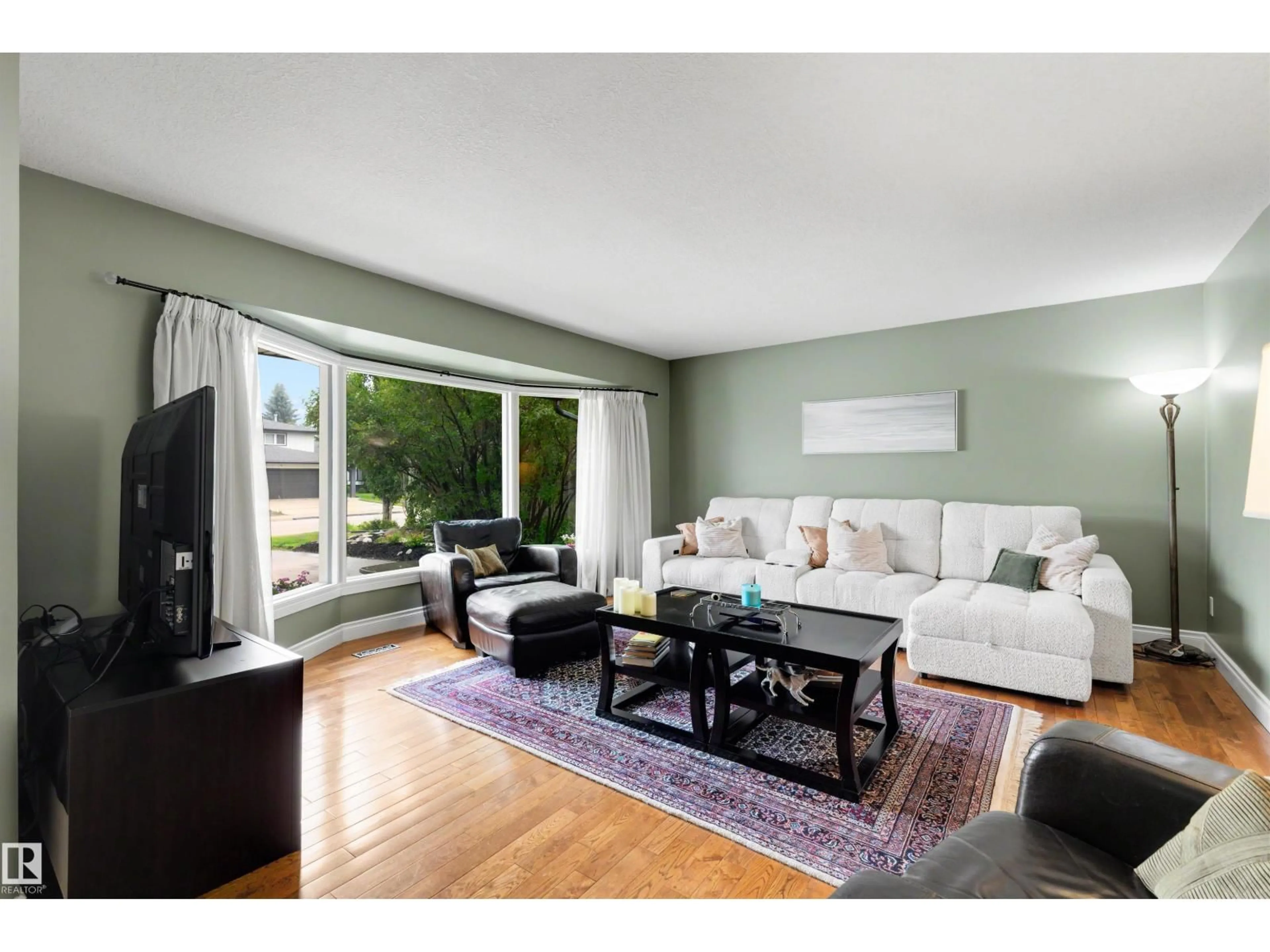 Living room with furniture, wood/laminate floor for NW - 11233 34A AV, Edmonton Alberta T6J3M4